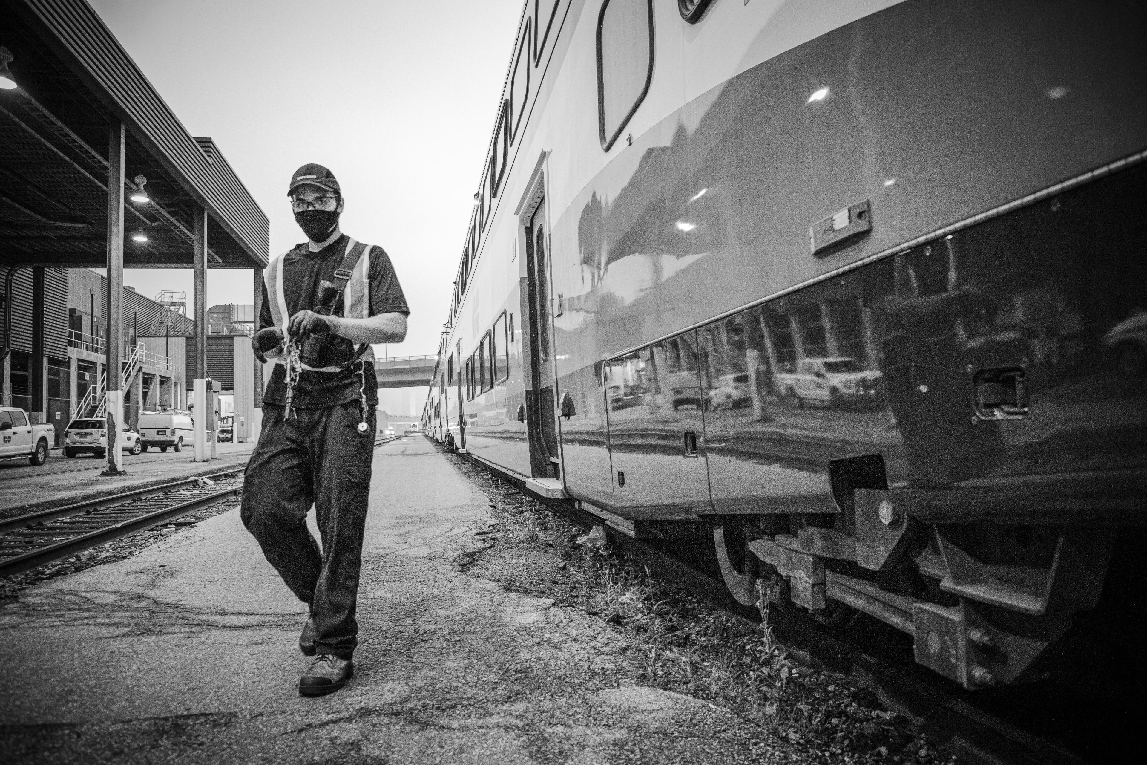 A man walks past a train.
