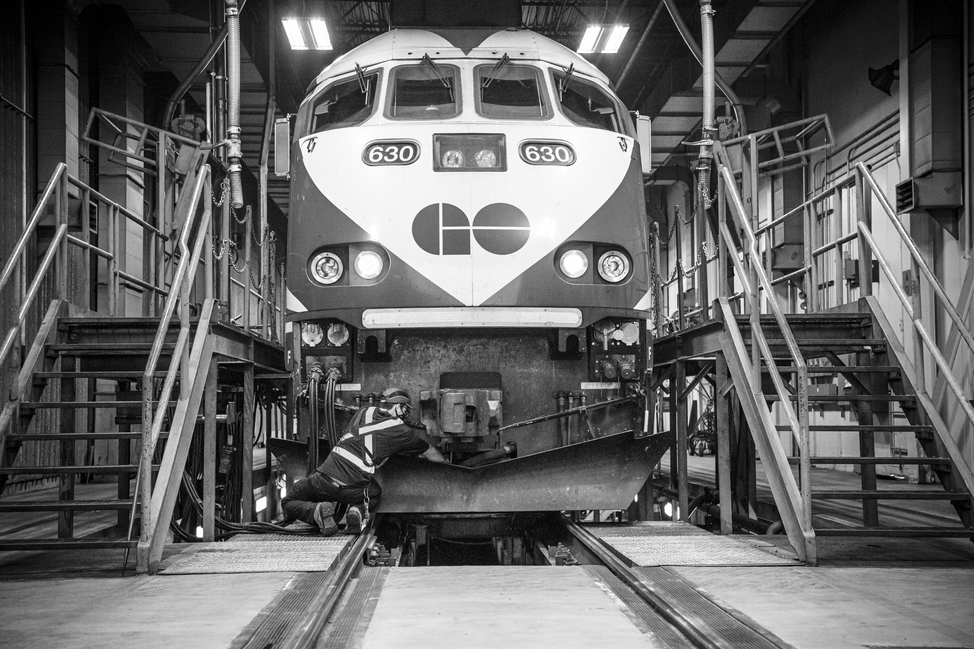 A man works on the front of a train.