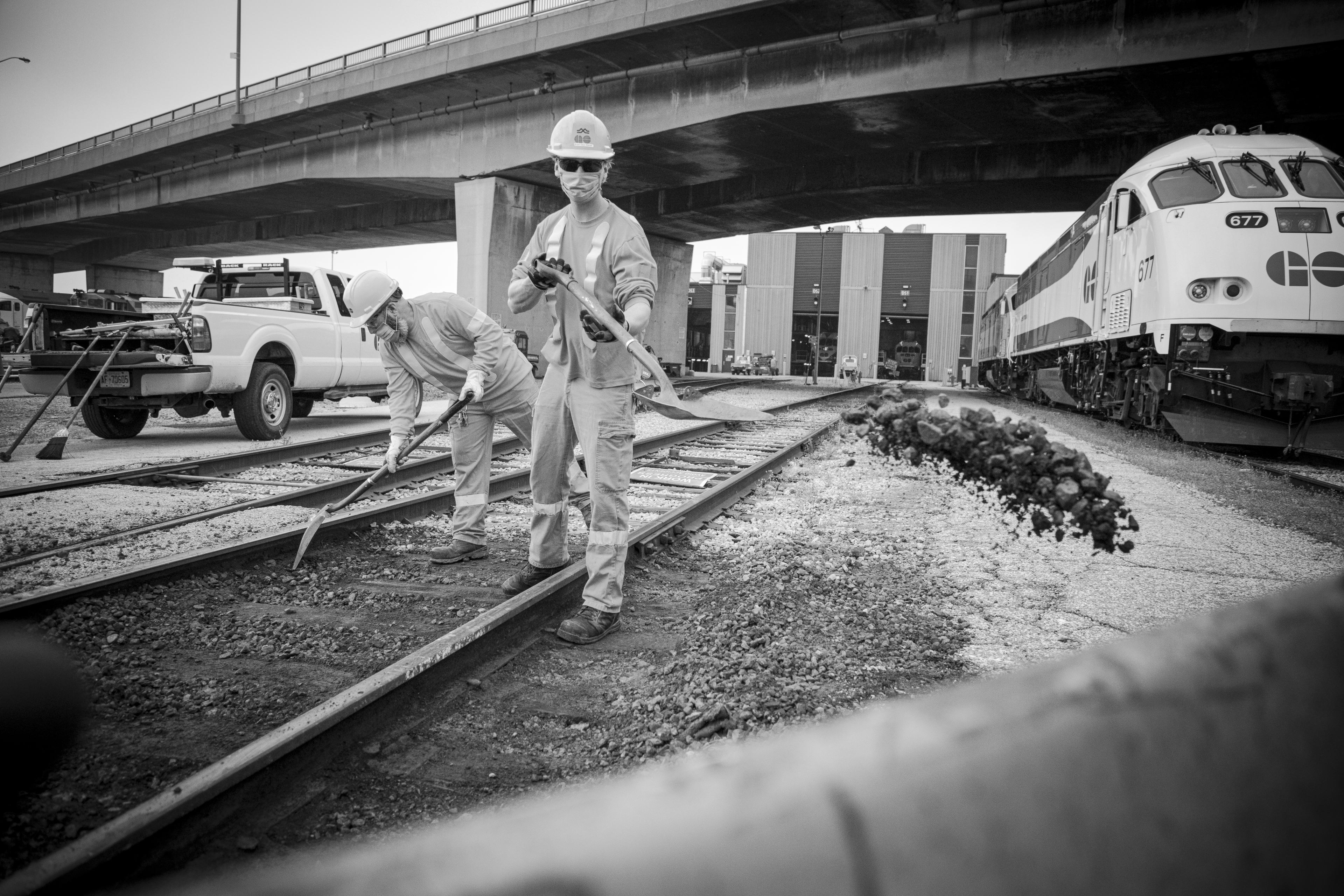 A man shovels dirt.