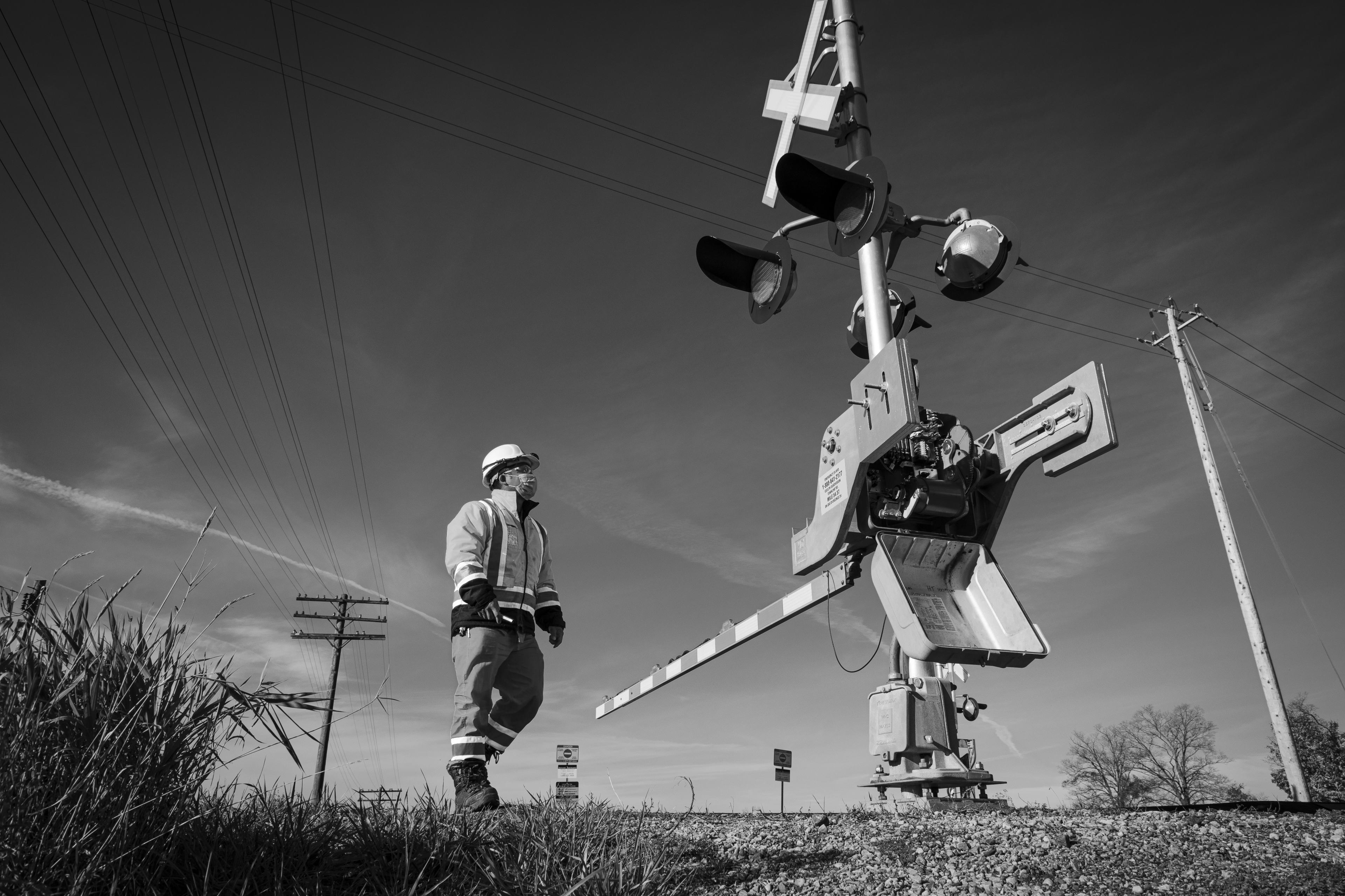 A man walks beside a crossing.