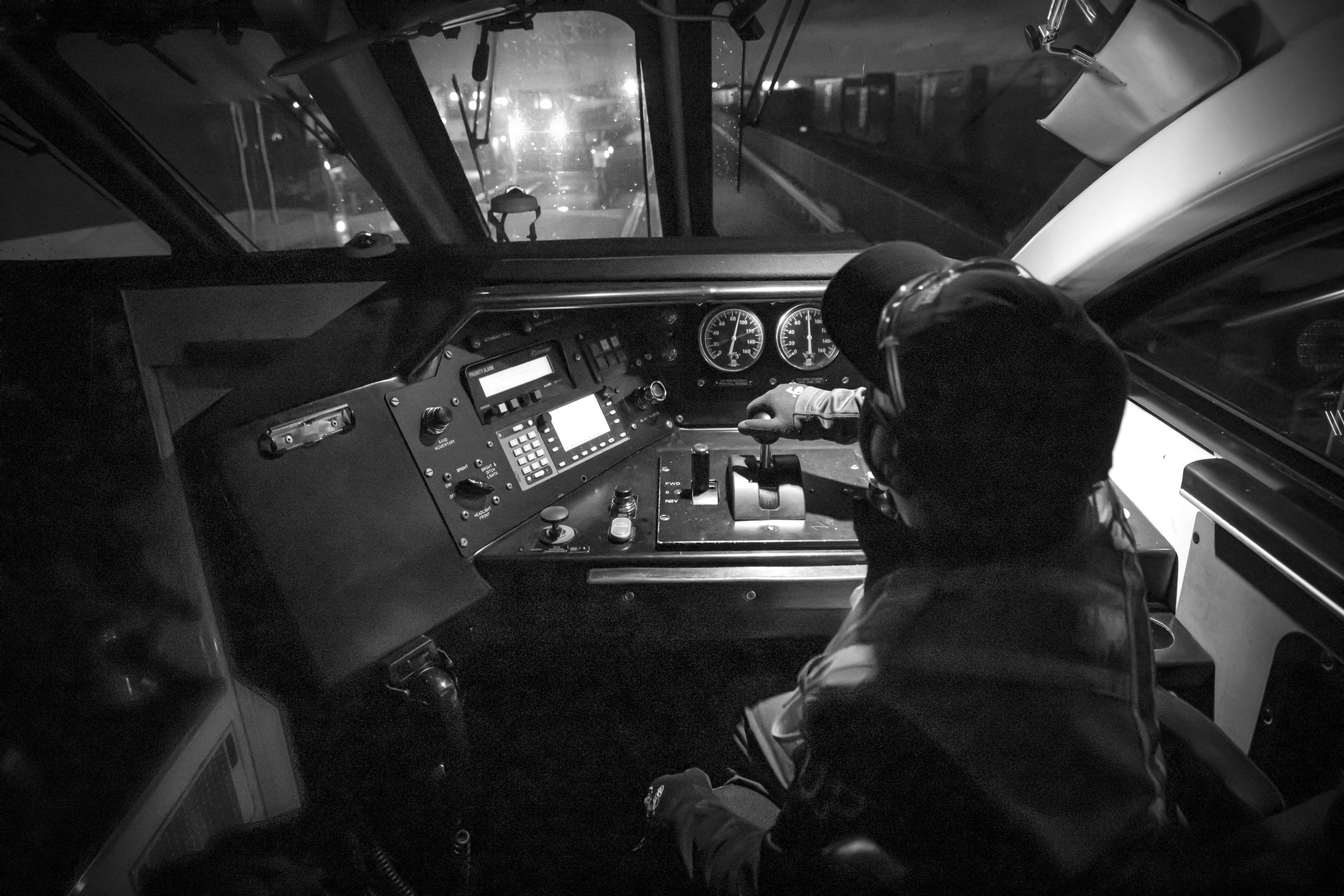 A man sits at the controls of a GO train.