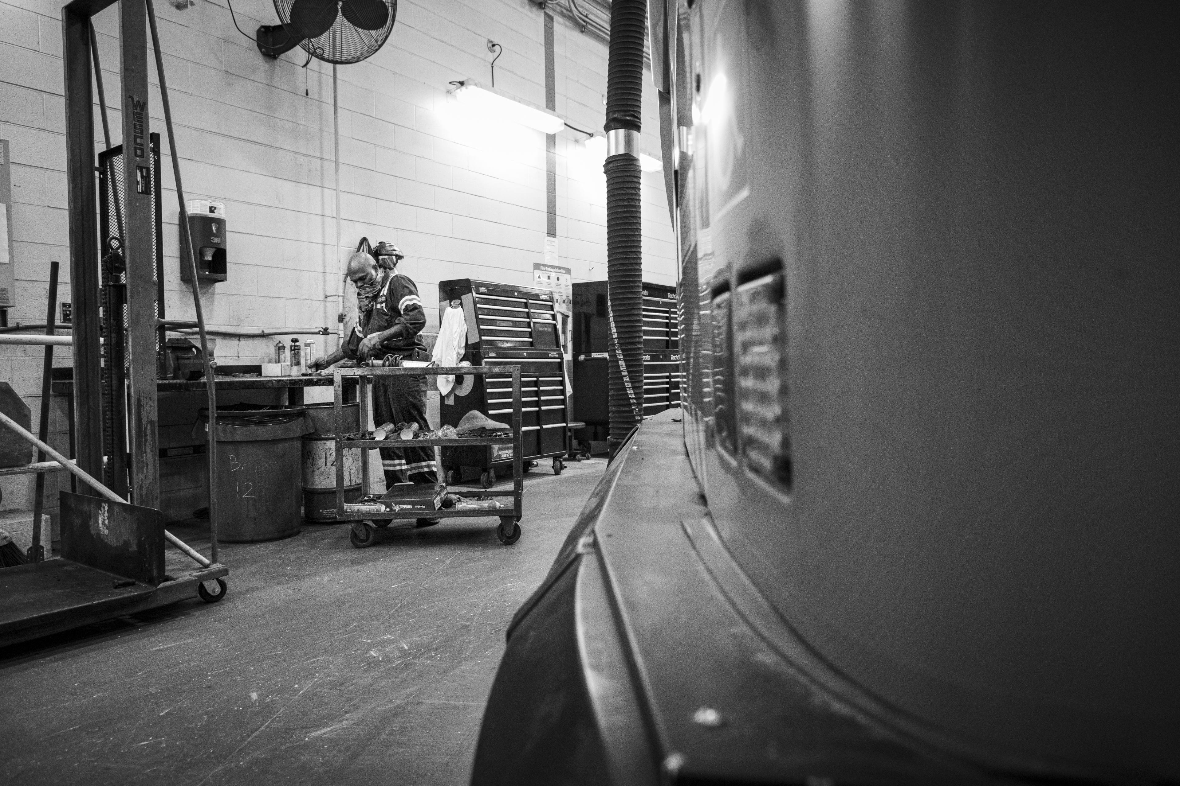 A man works at a bench.