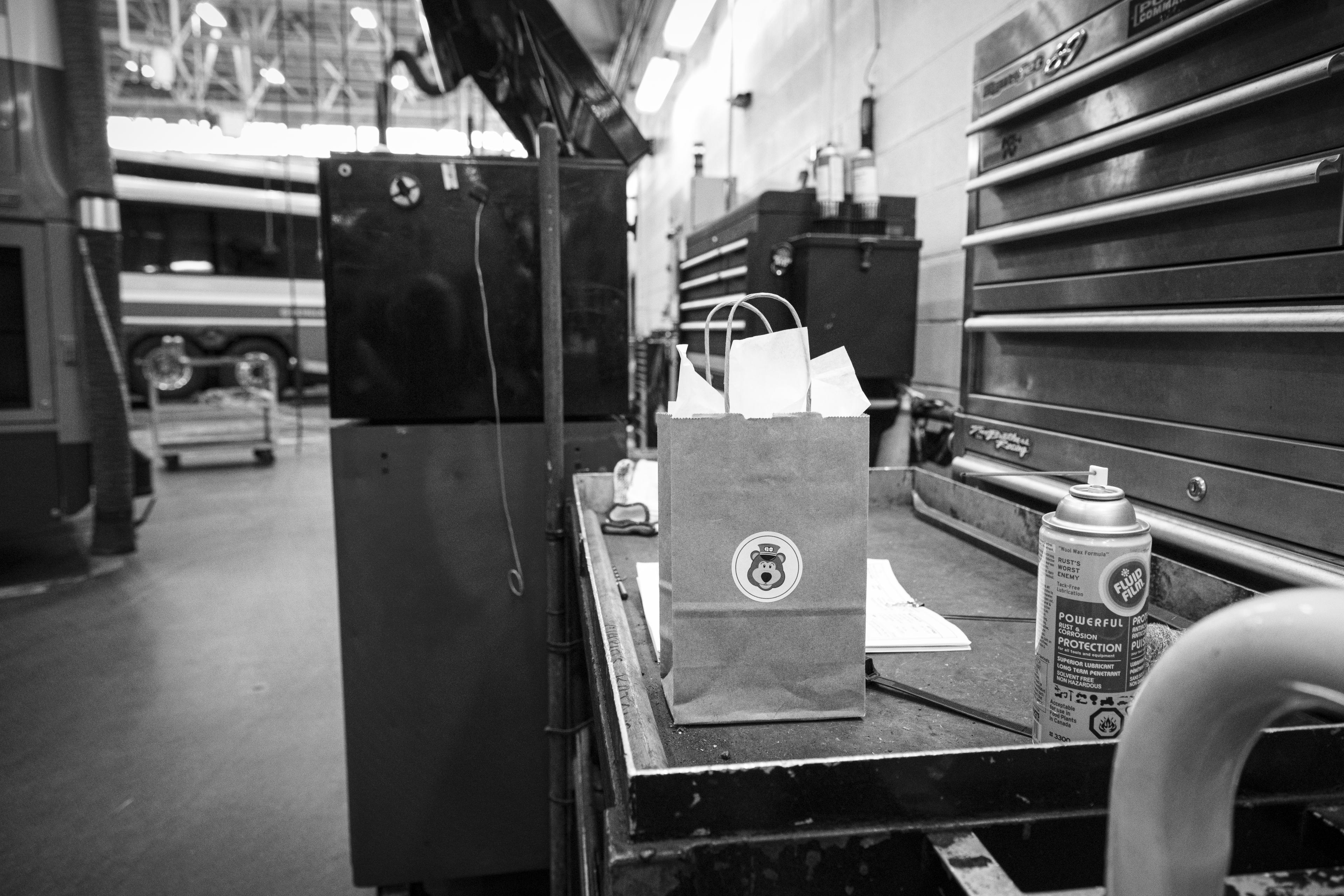 A bag sits on a work bench.