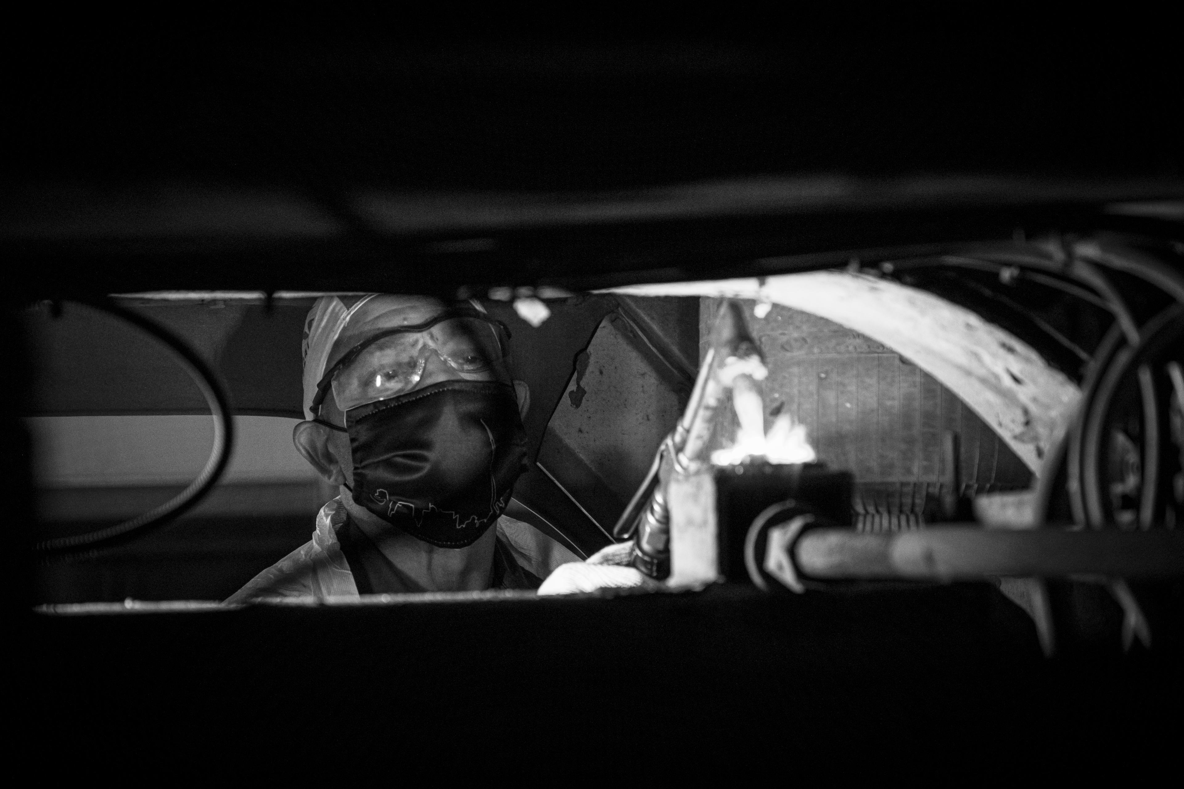 A man works on a bus.