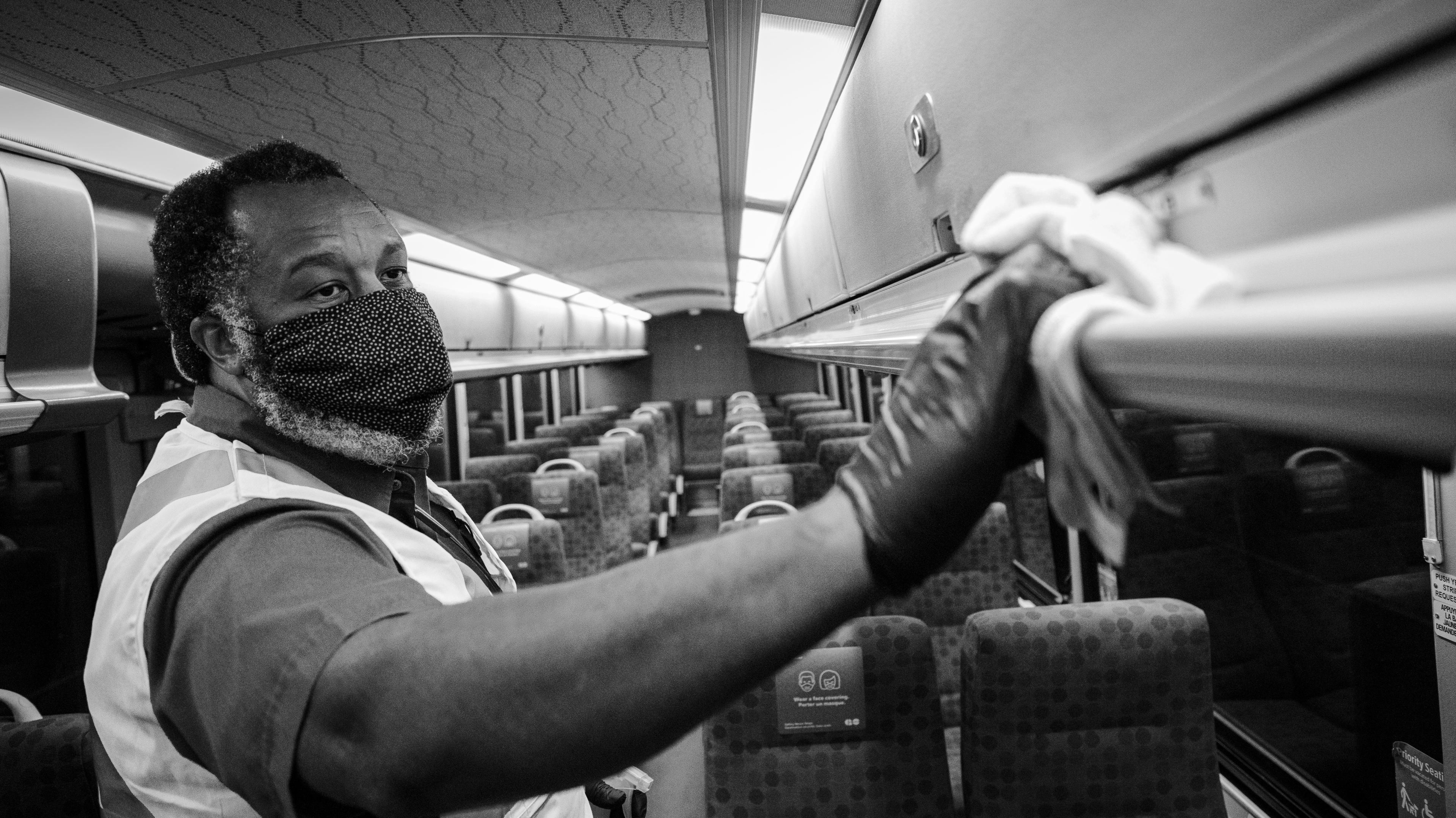 A worker scrubs the inside of a bus.