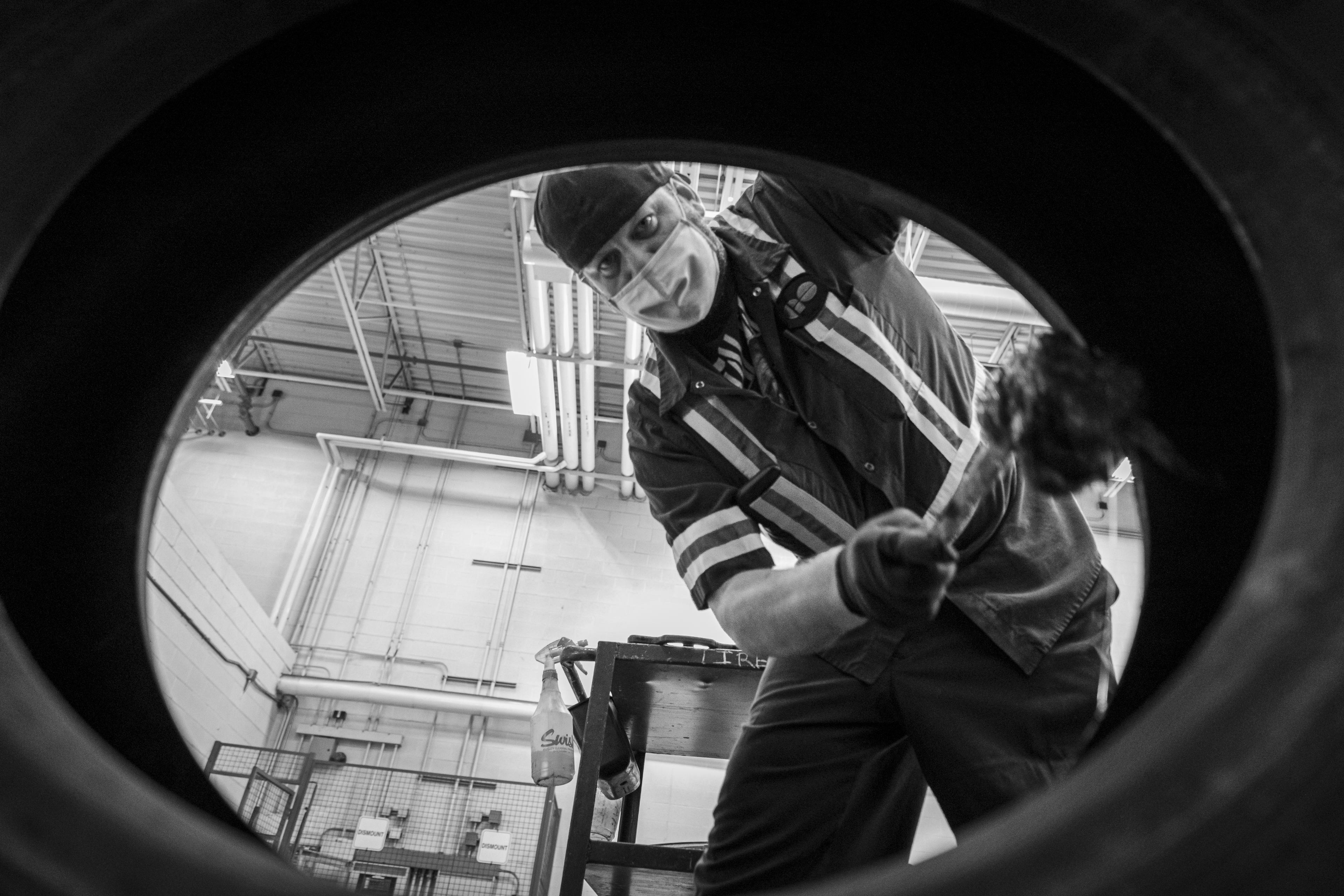 A man works on a tire.