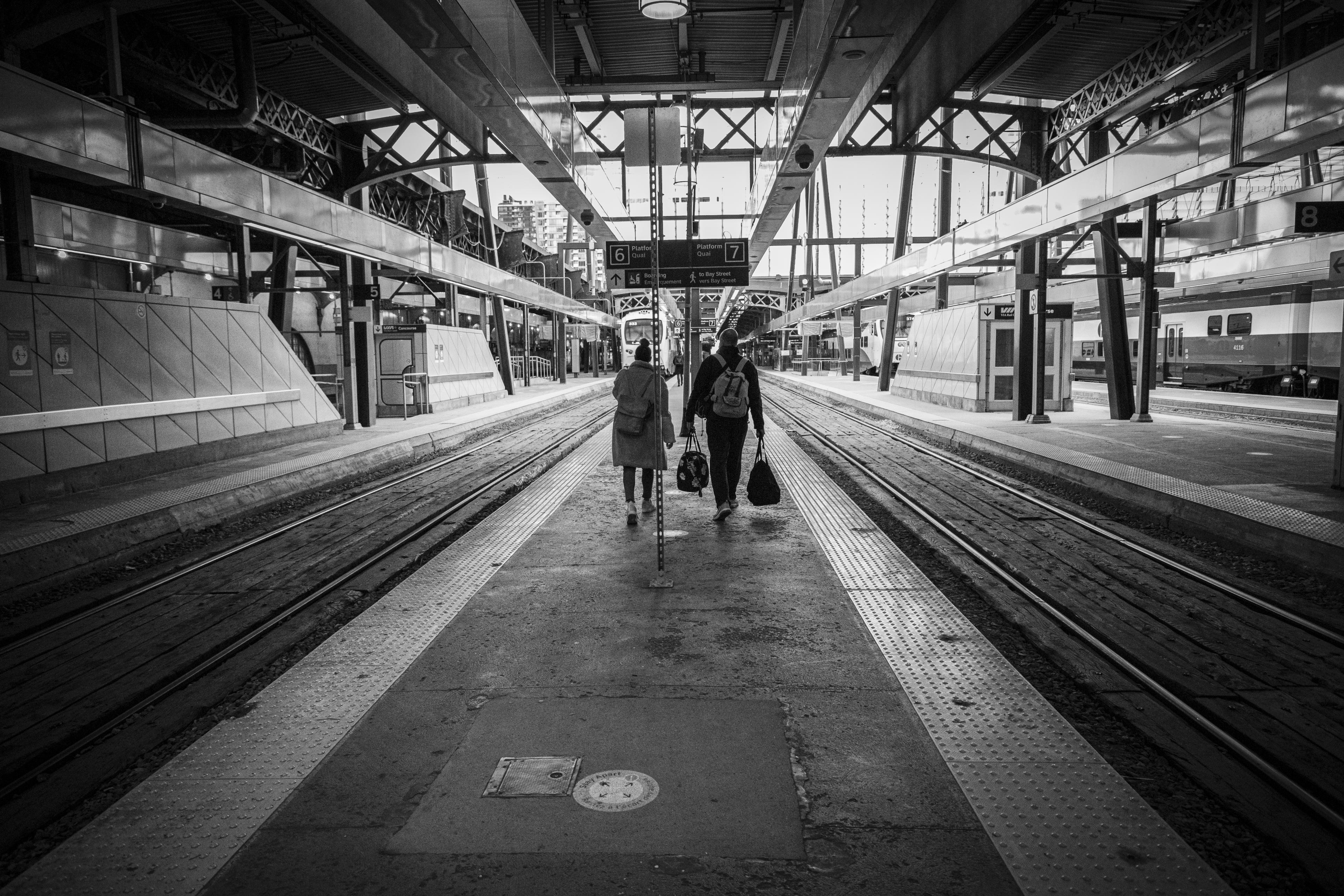 A couple walks along a platform.