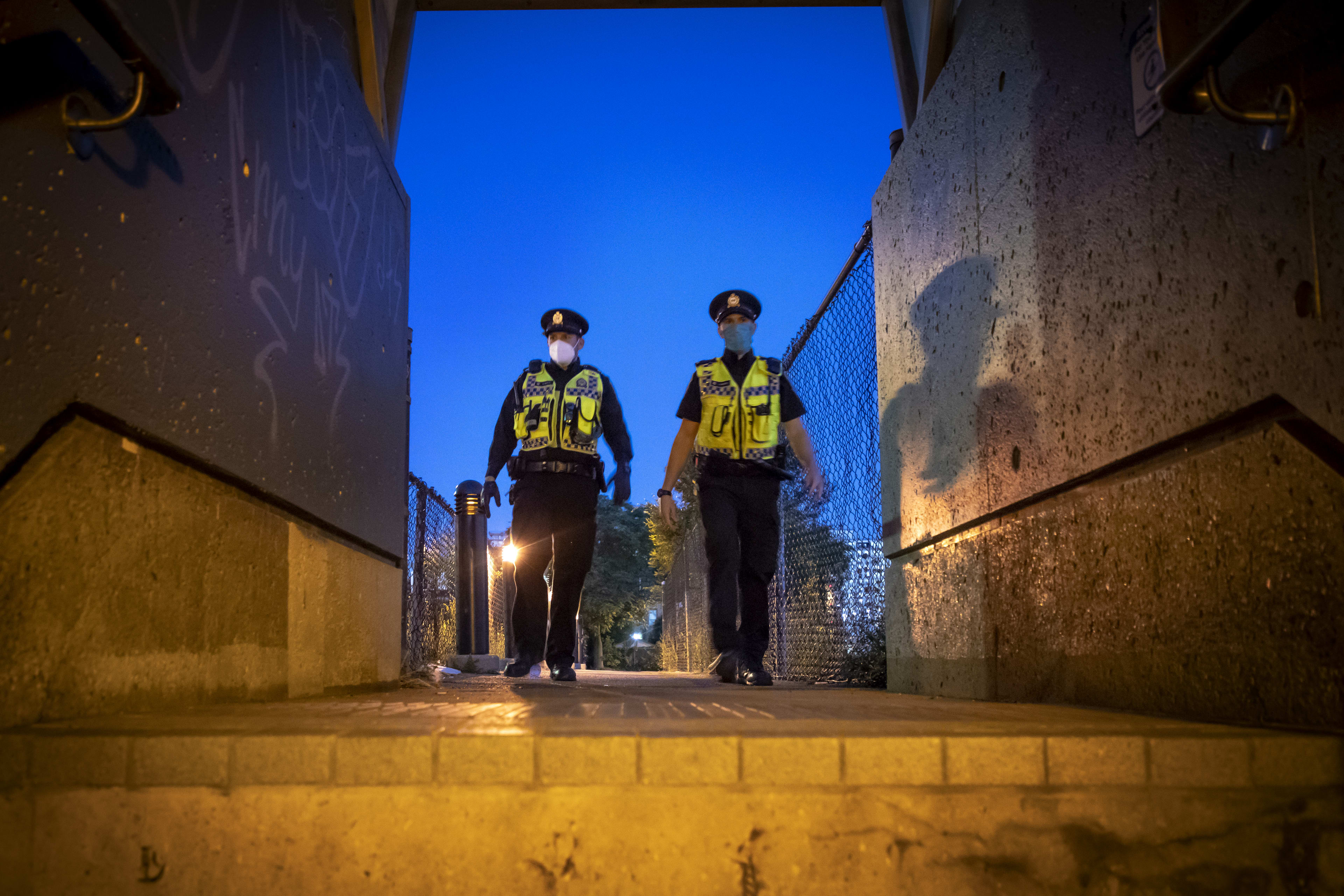 Two officer walk along a path.
