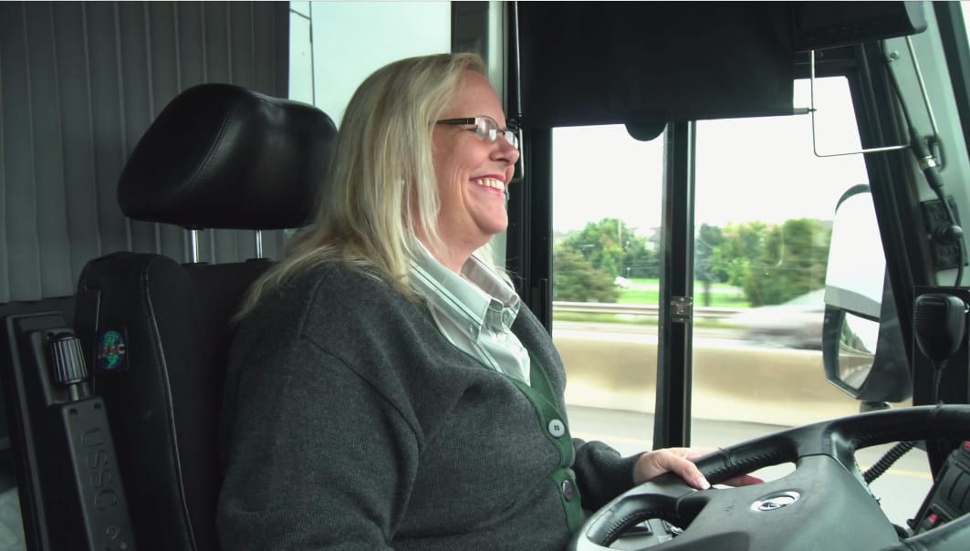 A driver is seen behind the wheel.