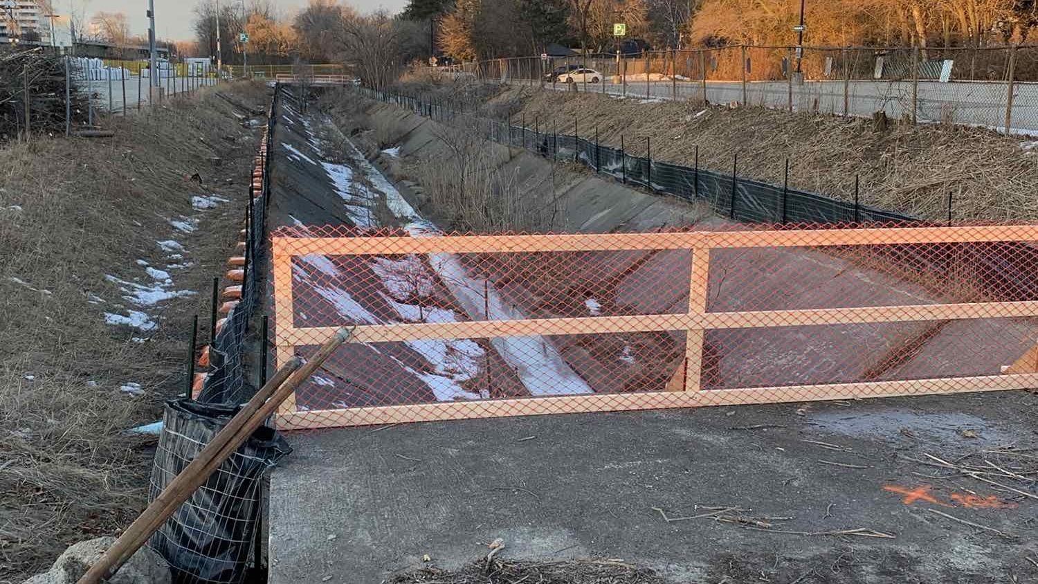 Construction fencing around a small creek
