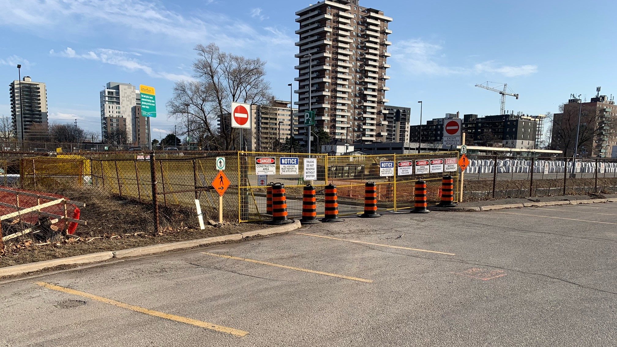 Construction fencing around a small creek in a parking lot at Port Credit GO