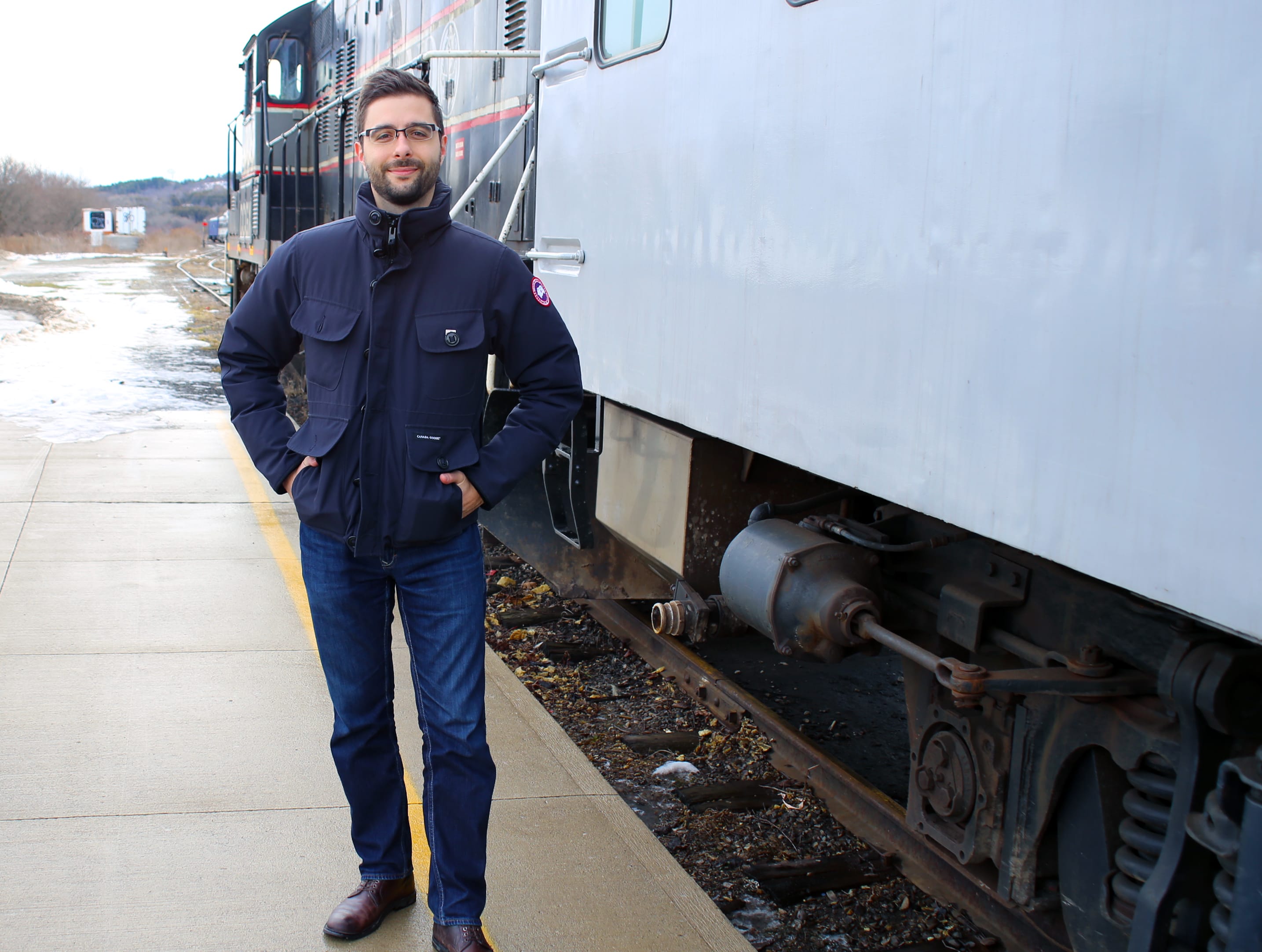 Christopher Balestri poses with a train