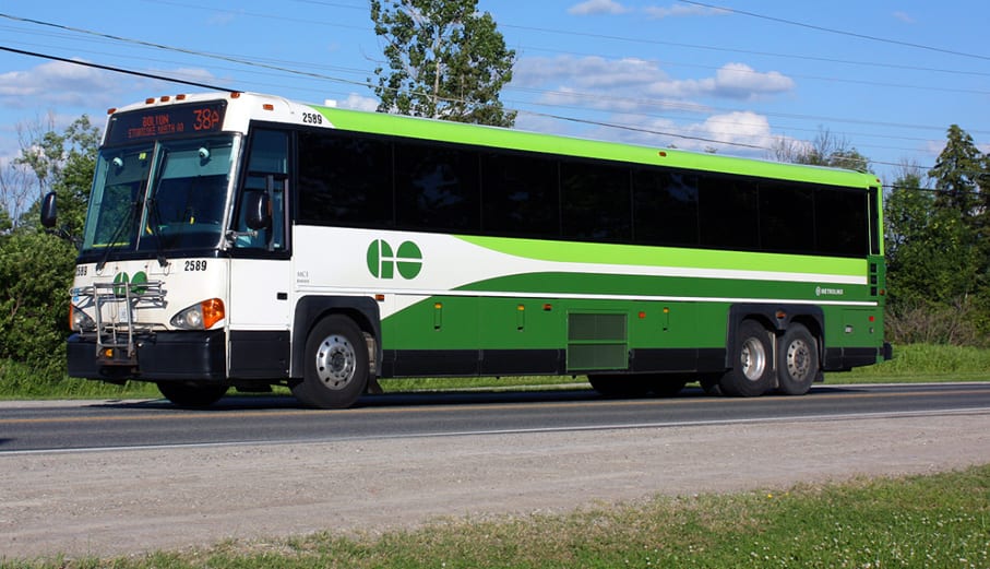 A GO bus driving along the road