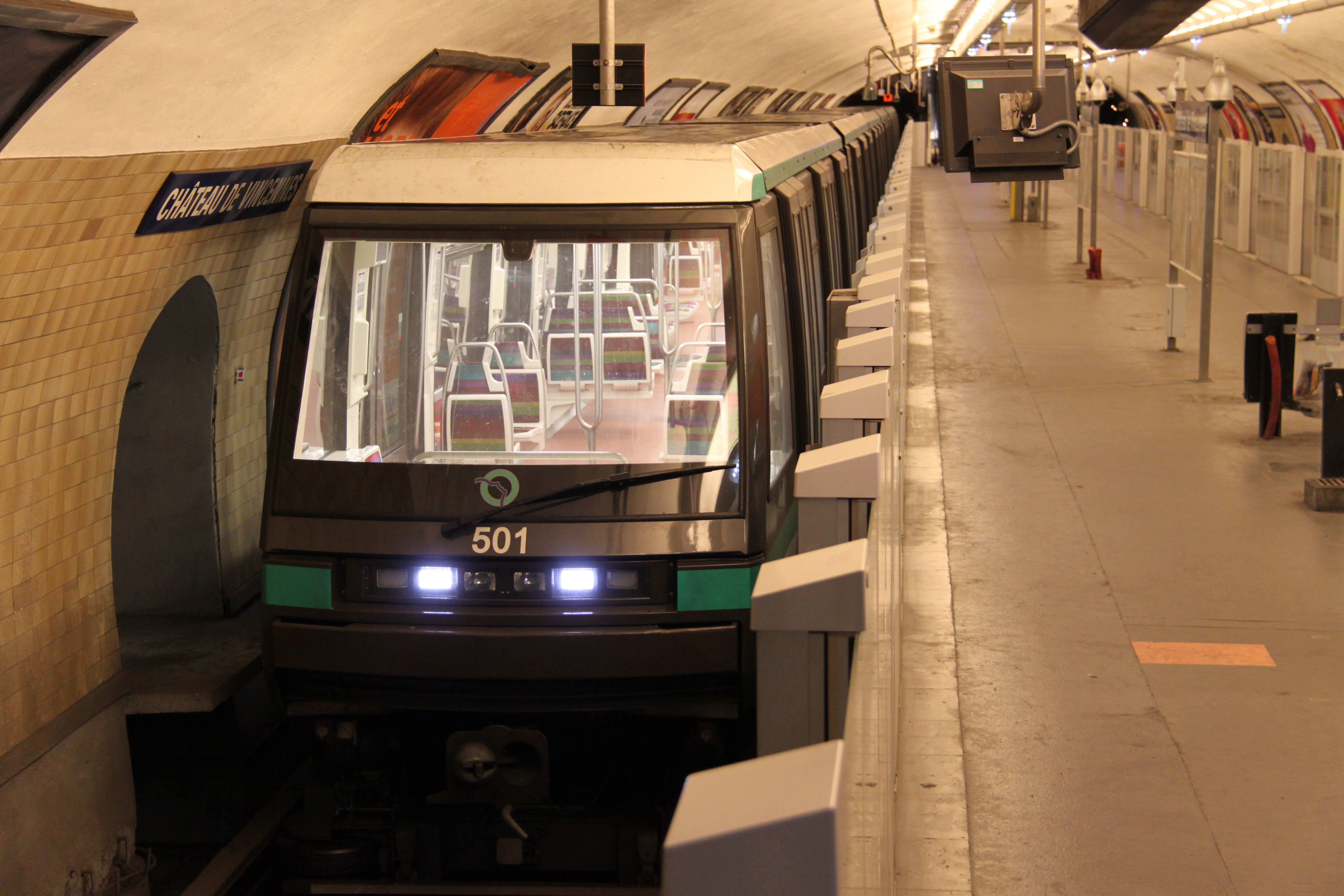A Paris subway train sits at the platform.