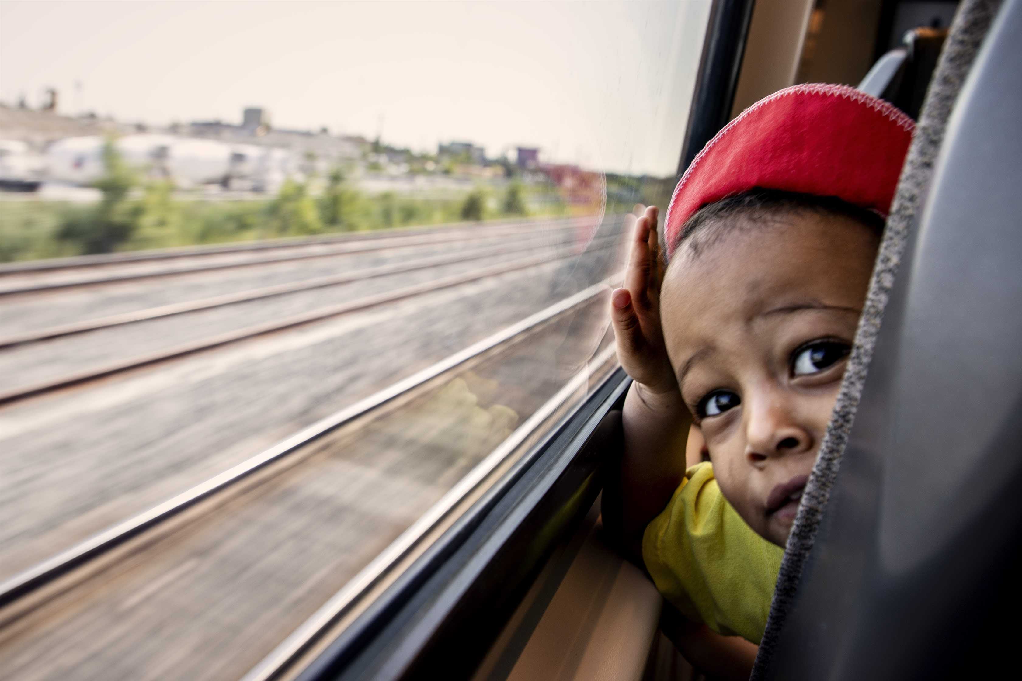 A child looks out the window of the UP train.