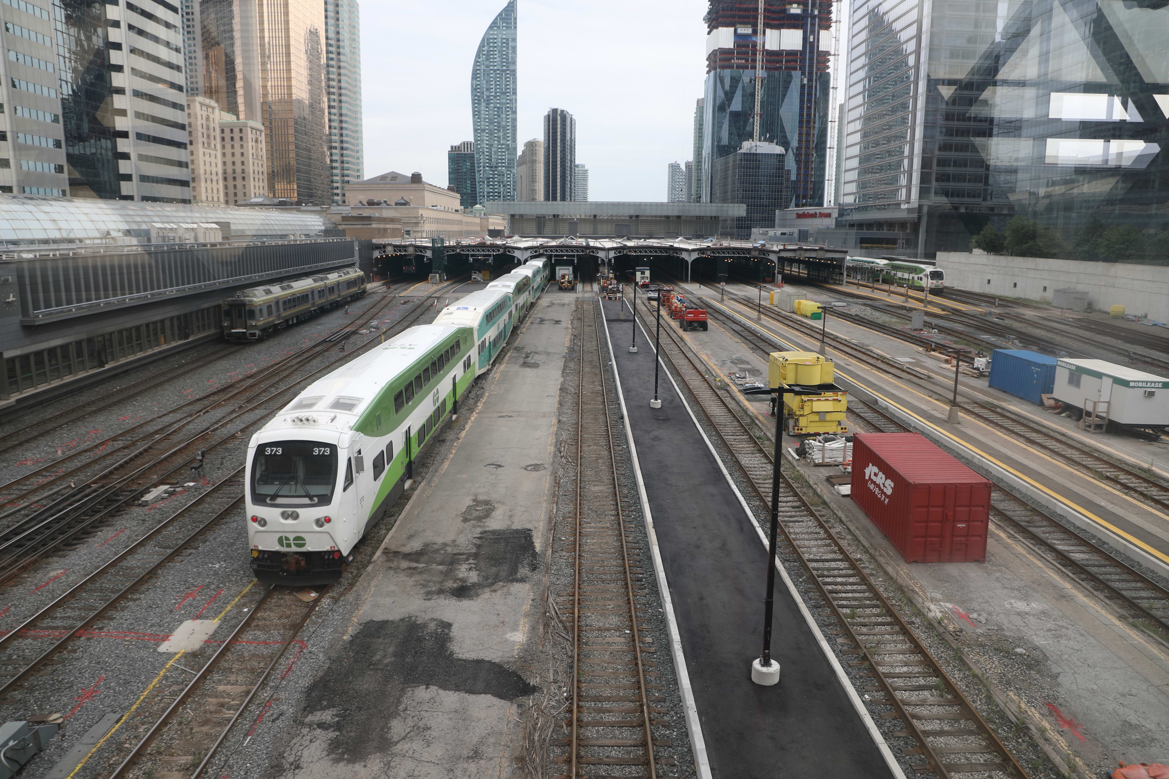 A concrete extension is shown jutting out from a Union Station platform, as a GO train arrives.