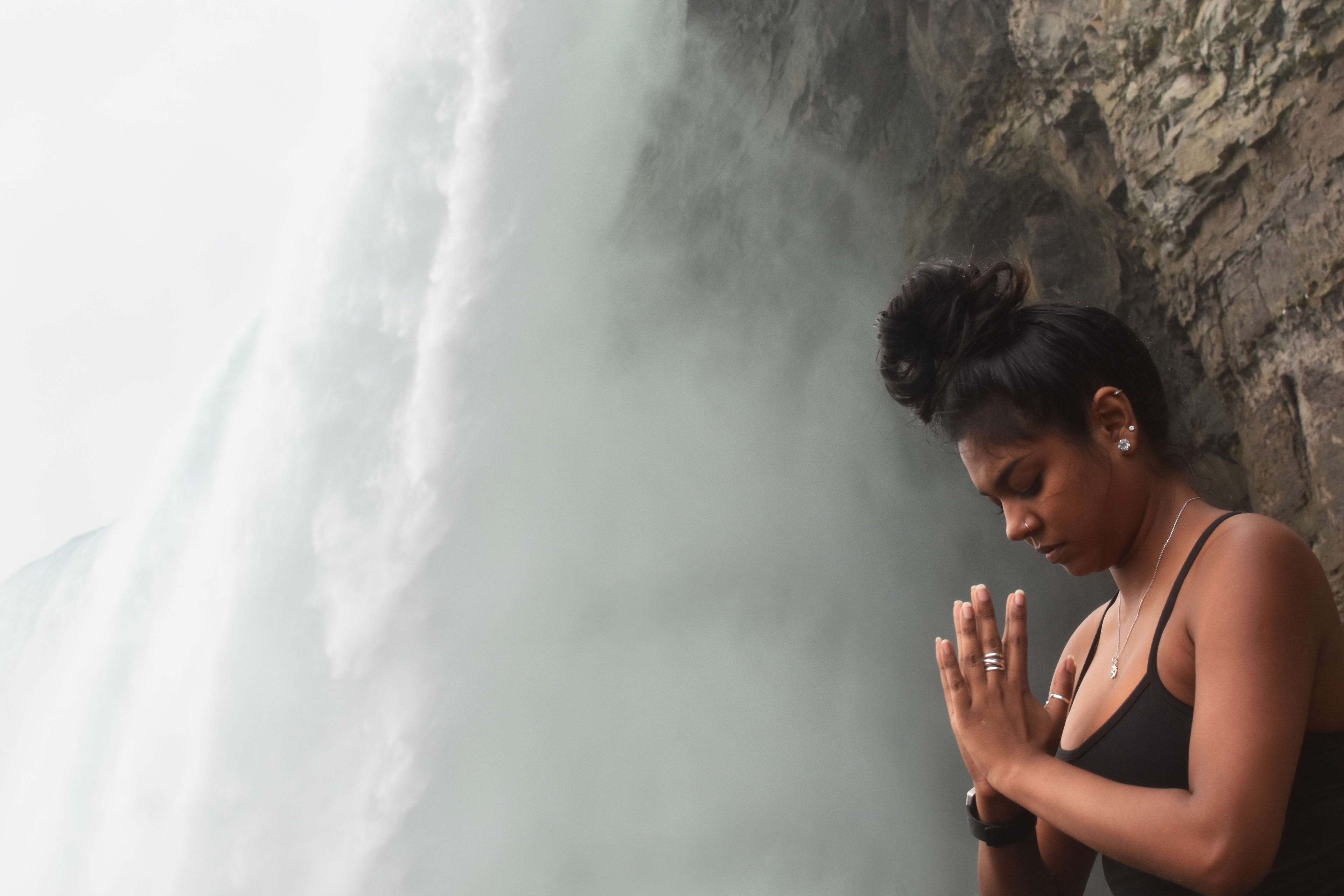 An instructor, eyes closed, meditates next to the roar of the Falls.