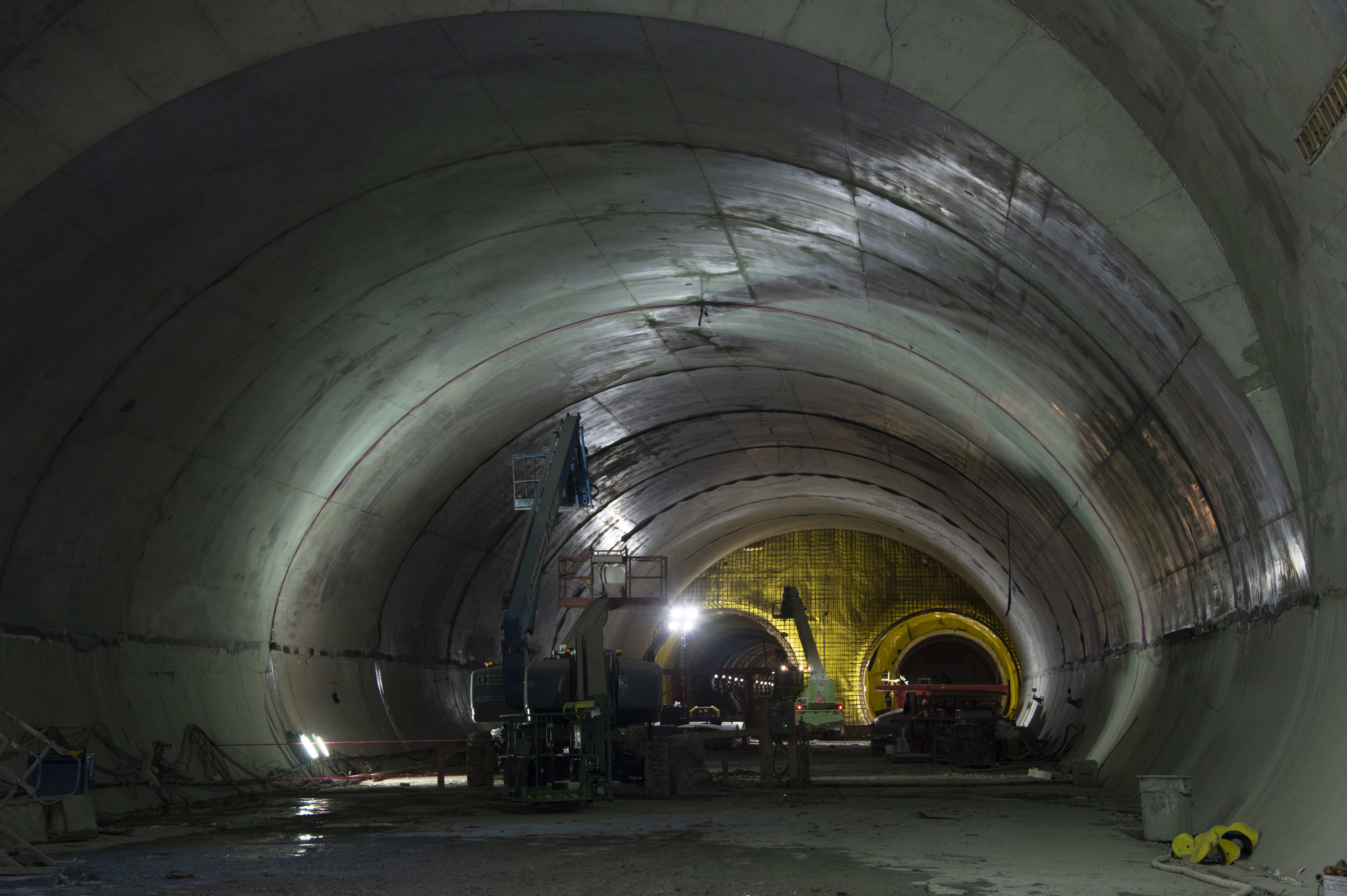 The tunnel is shown in concrete, as a cherry-picker crane reaches for the ceiling.