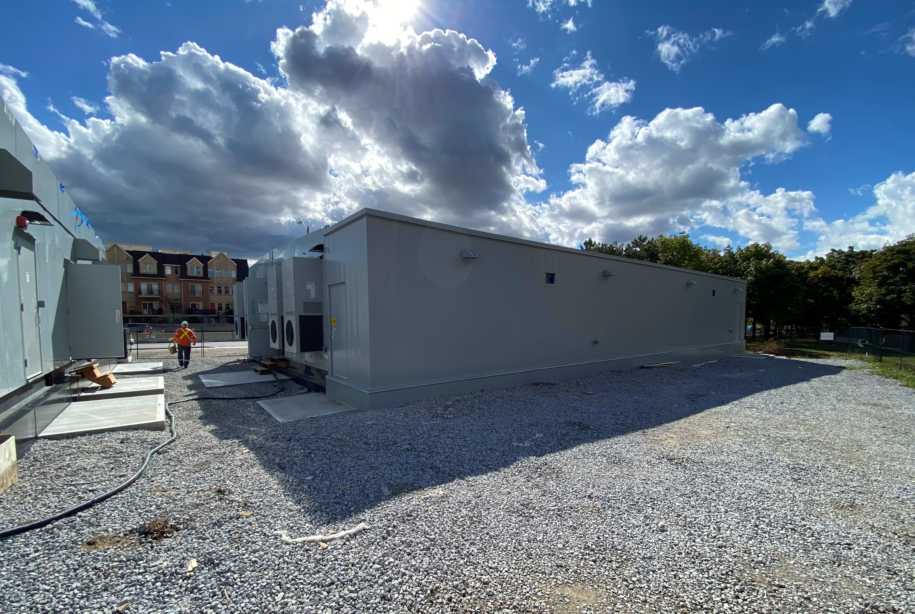 Large power boxes are shown, as a man walks away.
