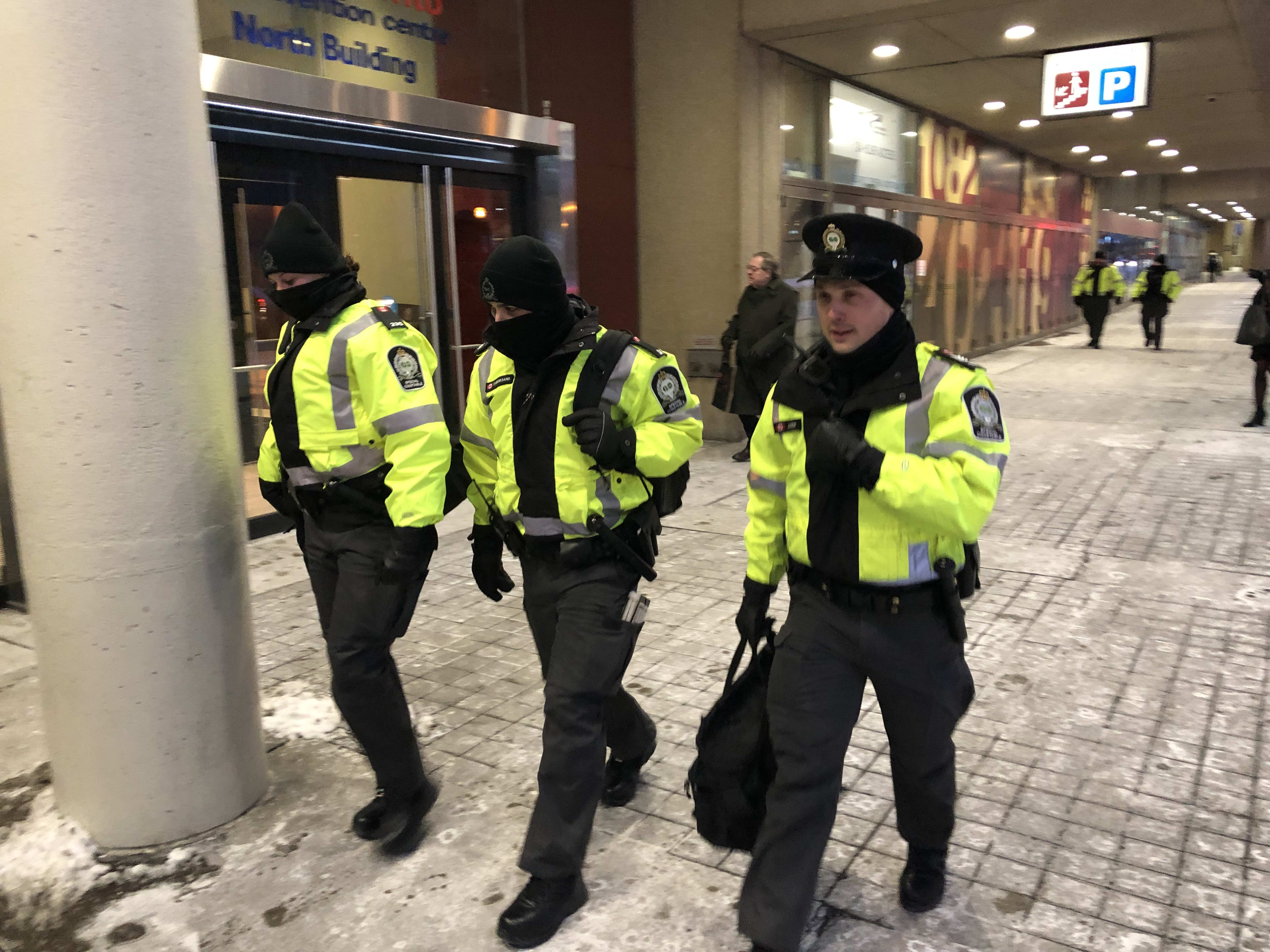 Three transit officers, including Tihana Karanovic, are bundled up and head down a sidewalk towar...