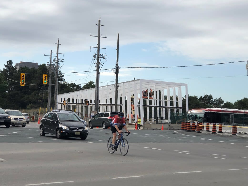 A man rides a bike through the intersection.