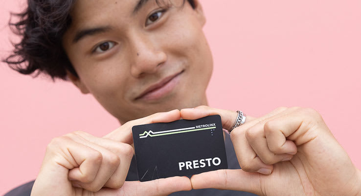 A person holds a PRESTO card.