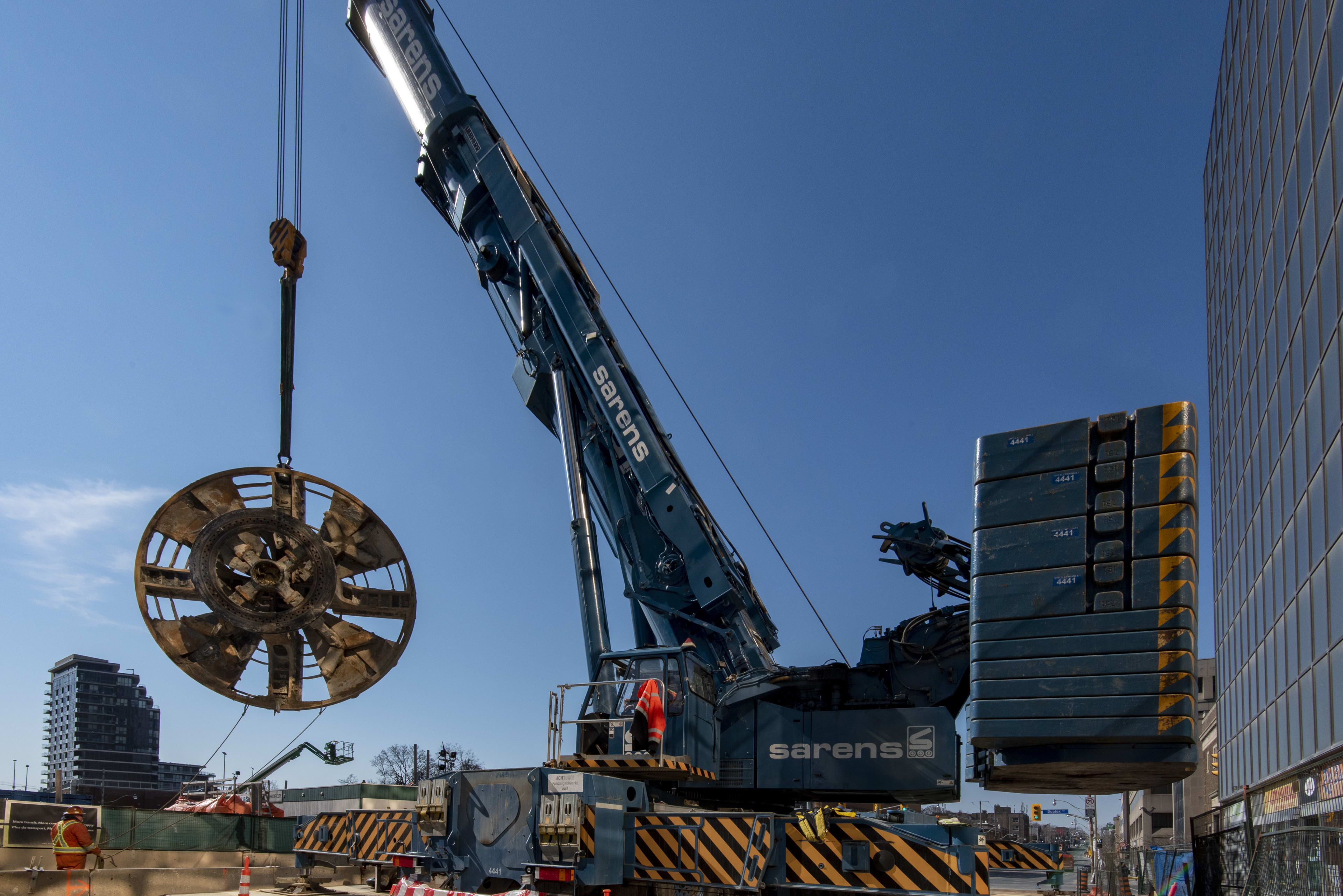 The 6-metre long cutter head from one of the tunnel boring machines is lifted from deep undergrou...