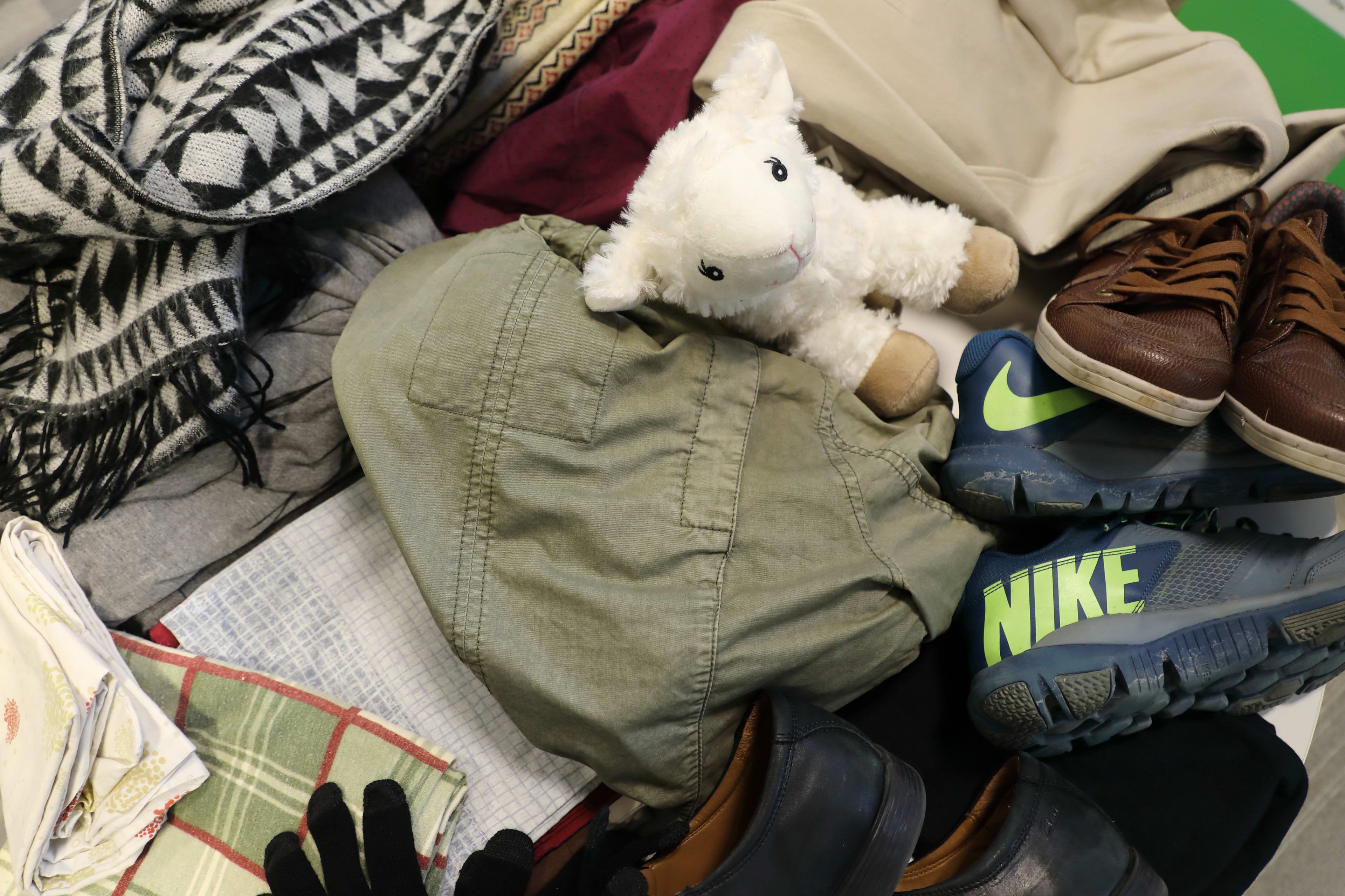 close up on a pile of textiles, shoes, stuffed animals