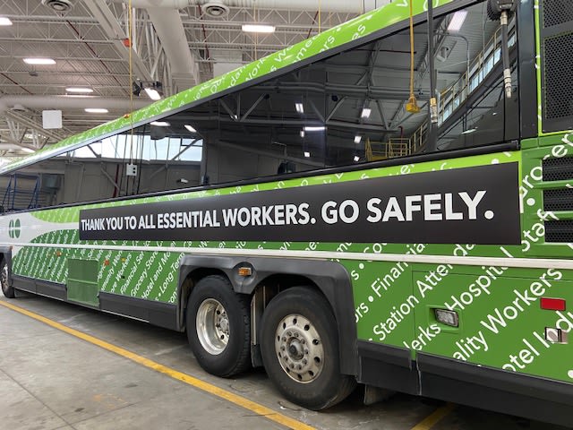 A GO bus features a sign that thanks essential workers.