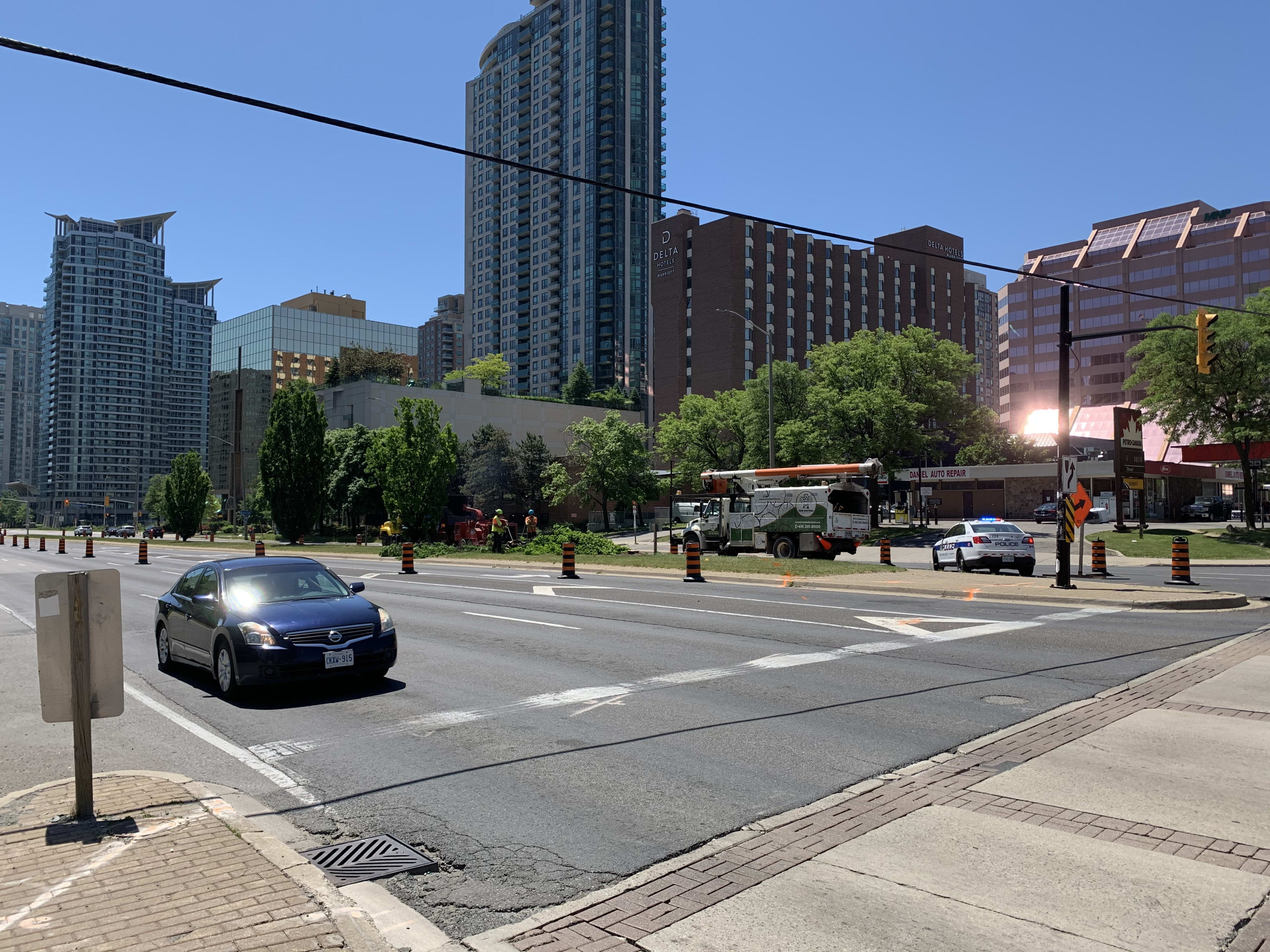 A pruning truck sits near some trees, on Hurontario St.