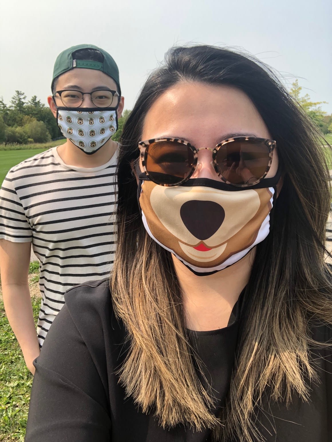 Two people wear face masks