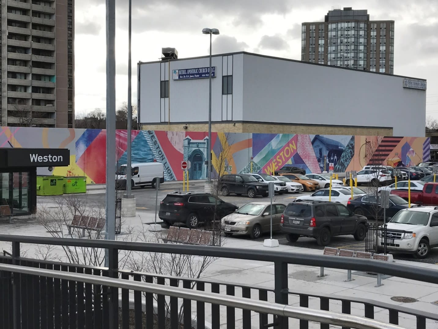 A wall mural is shown by the Weston station and parking lot.