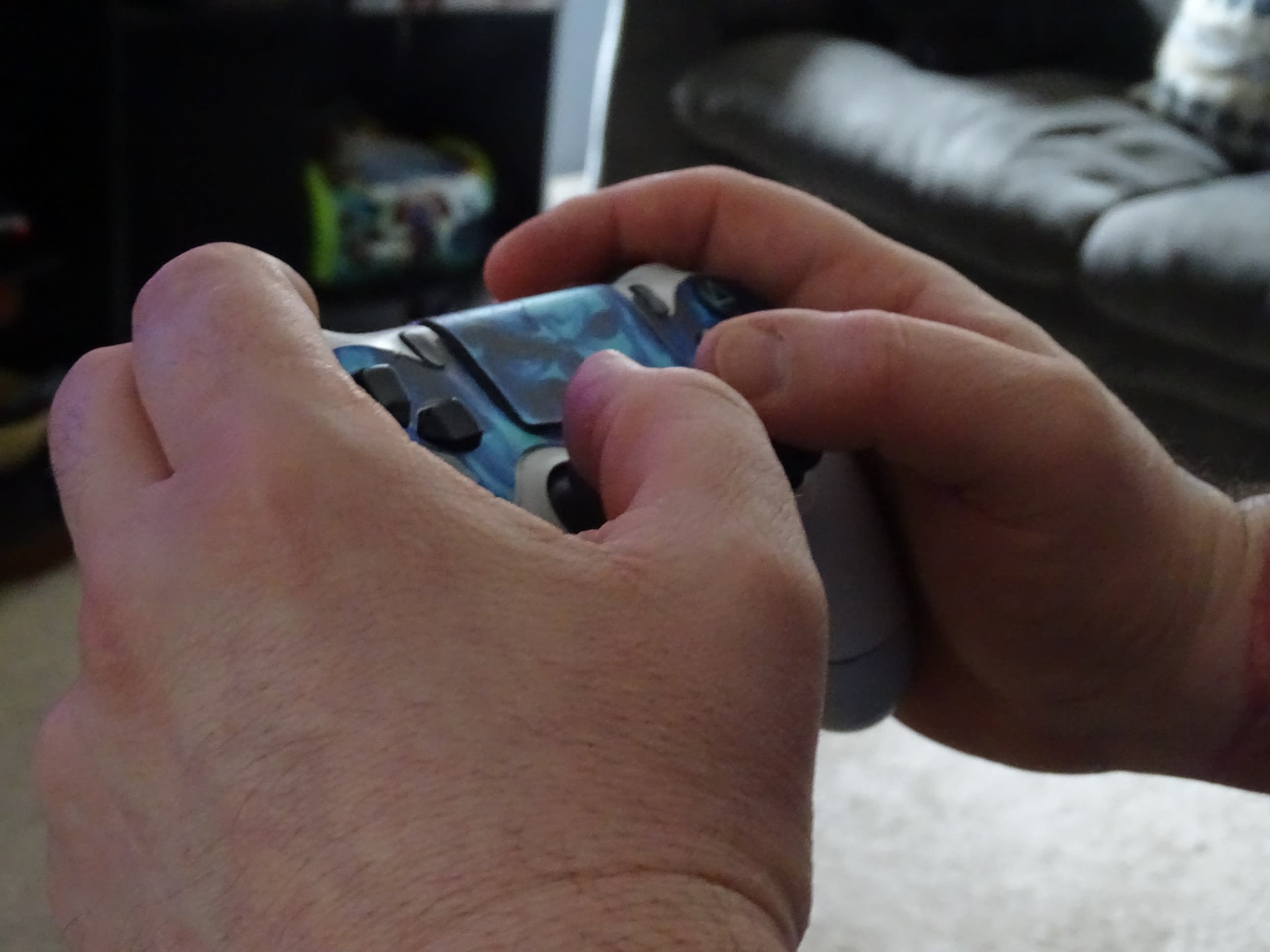 Hands hold a gaming controller.