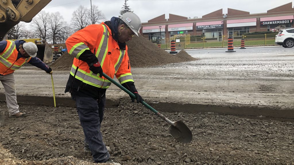 LRT construction worker with a shovel