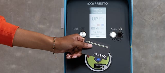 UP PRESTO device with a a female hand holding PRESTO card to be tapped