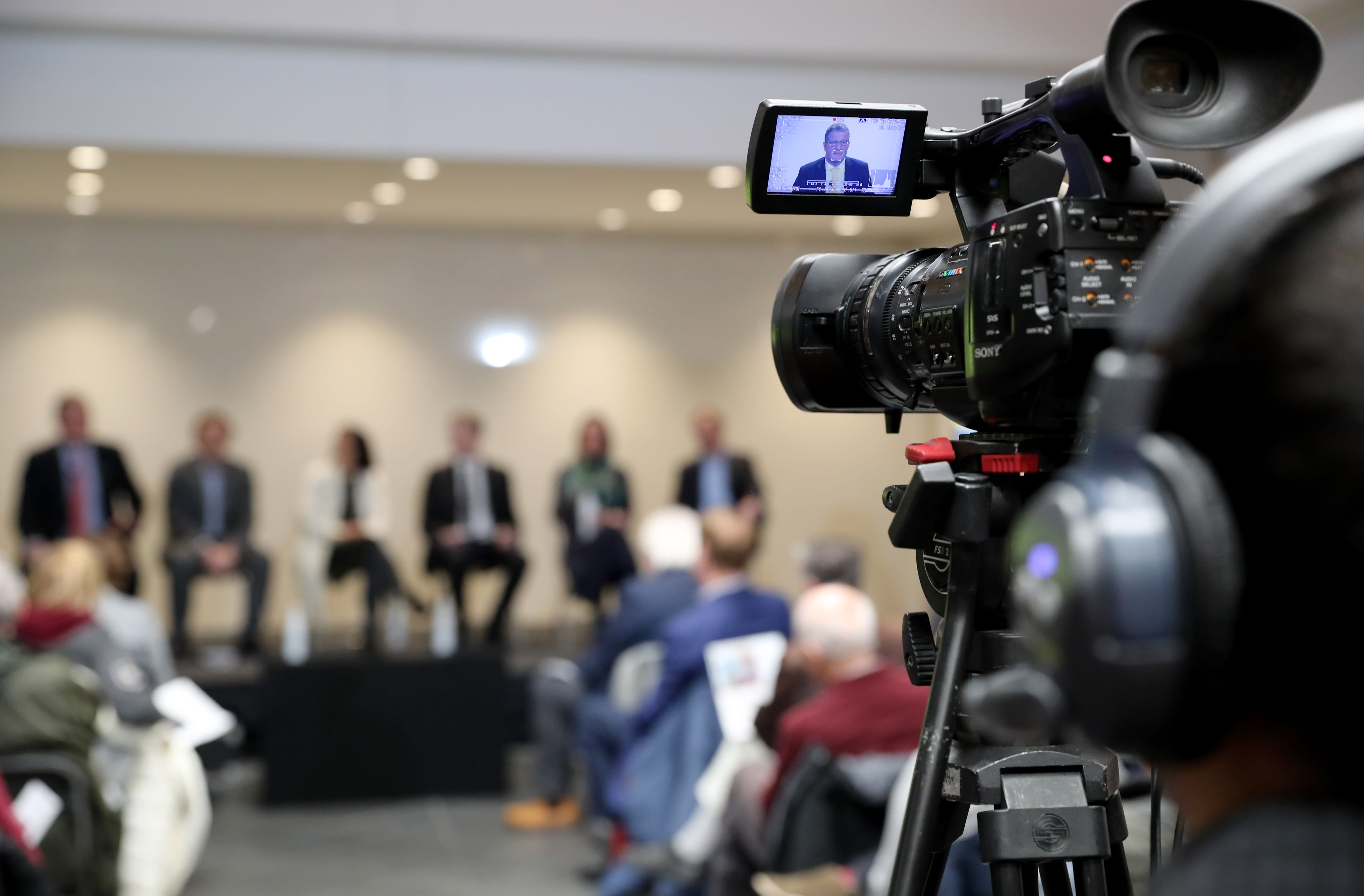 a camera pointed toward speakers.