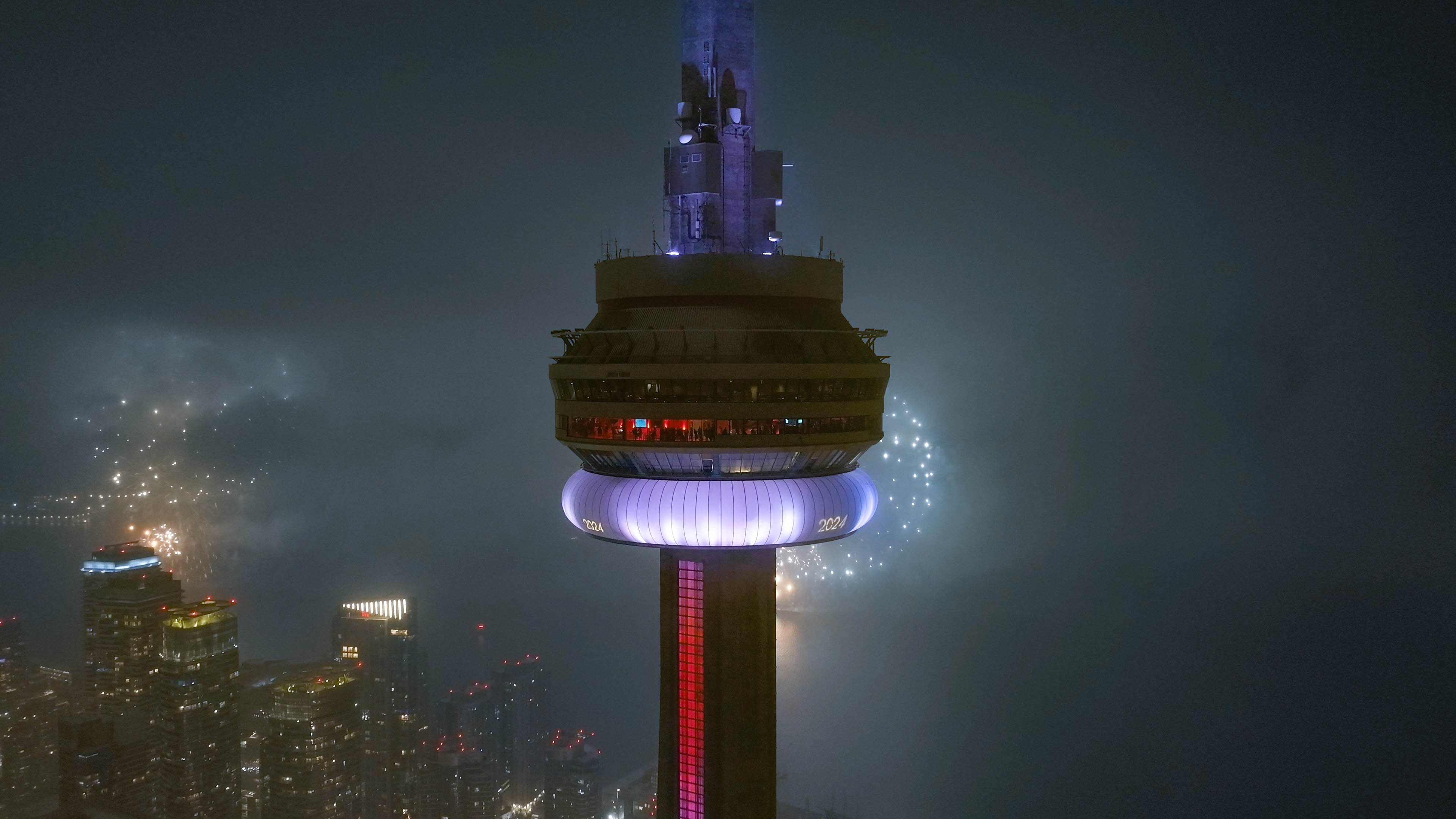 CN Tower lit up with fireworks for New Years Eve