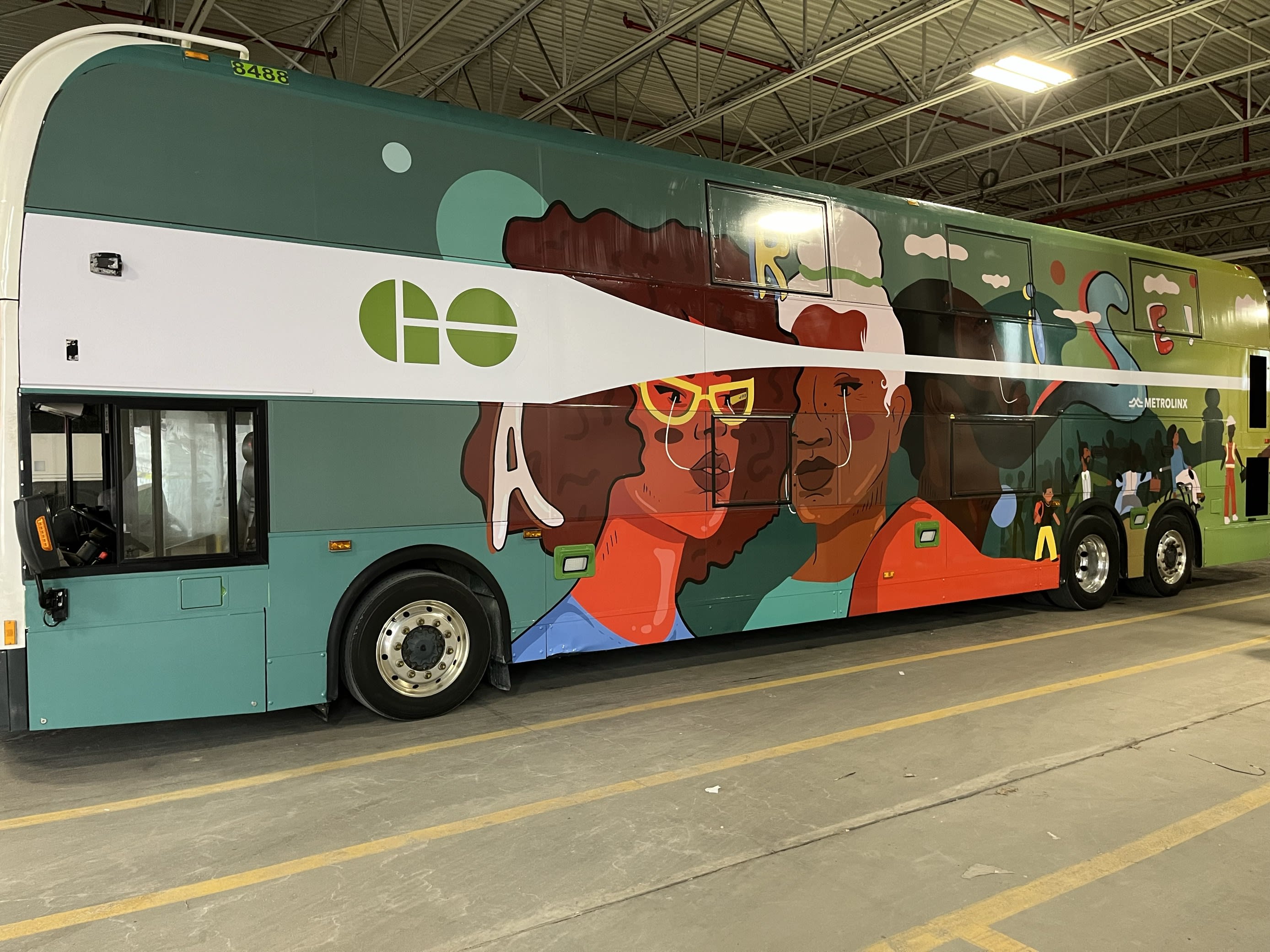 GO double decker bus wrapped for Black History Month with art designed by Alexis Eke
