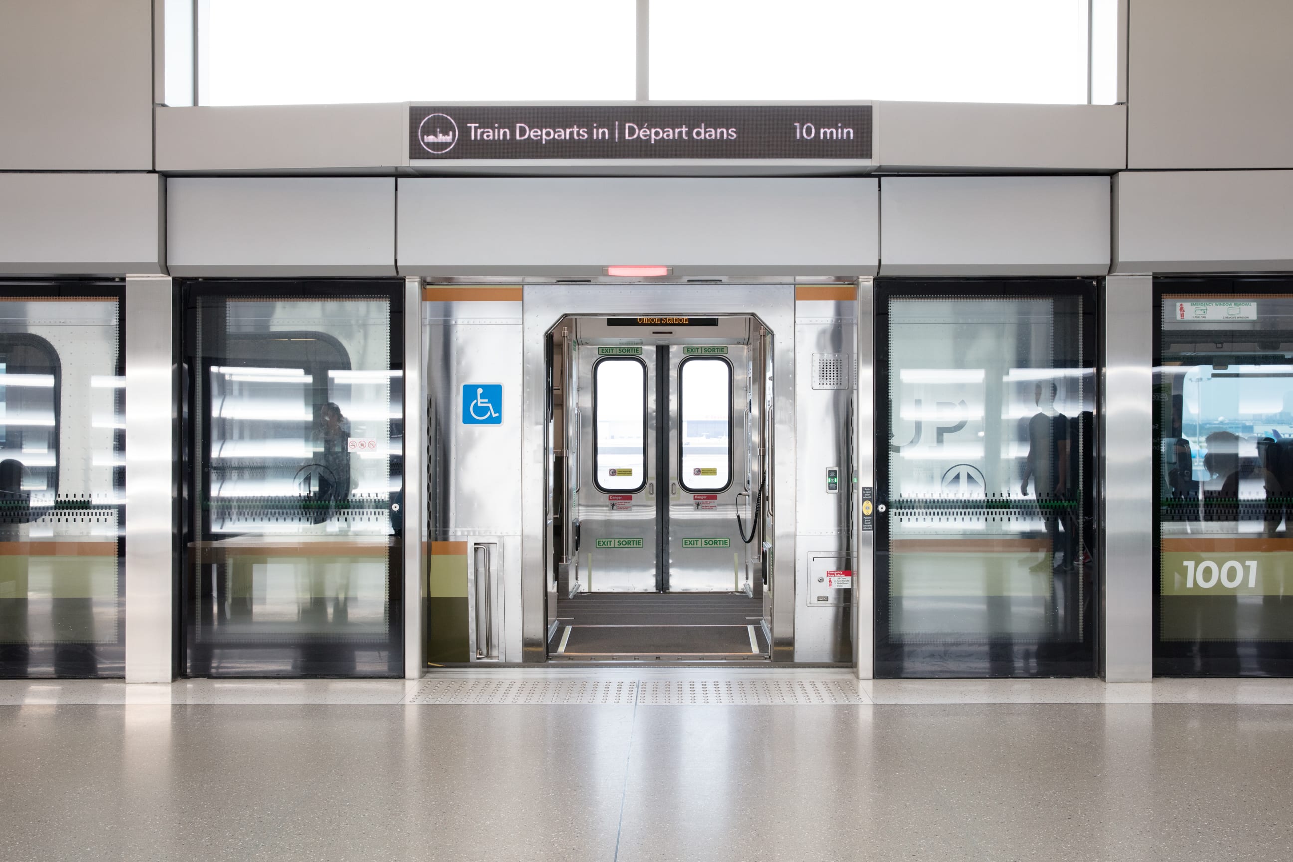 UP Express Pearson Station platform with train pulled into station and doors open