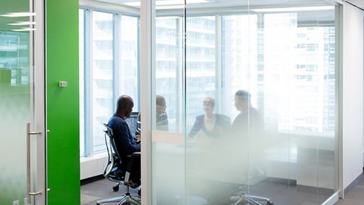 Leaders sitting around the table of a meeting room