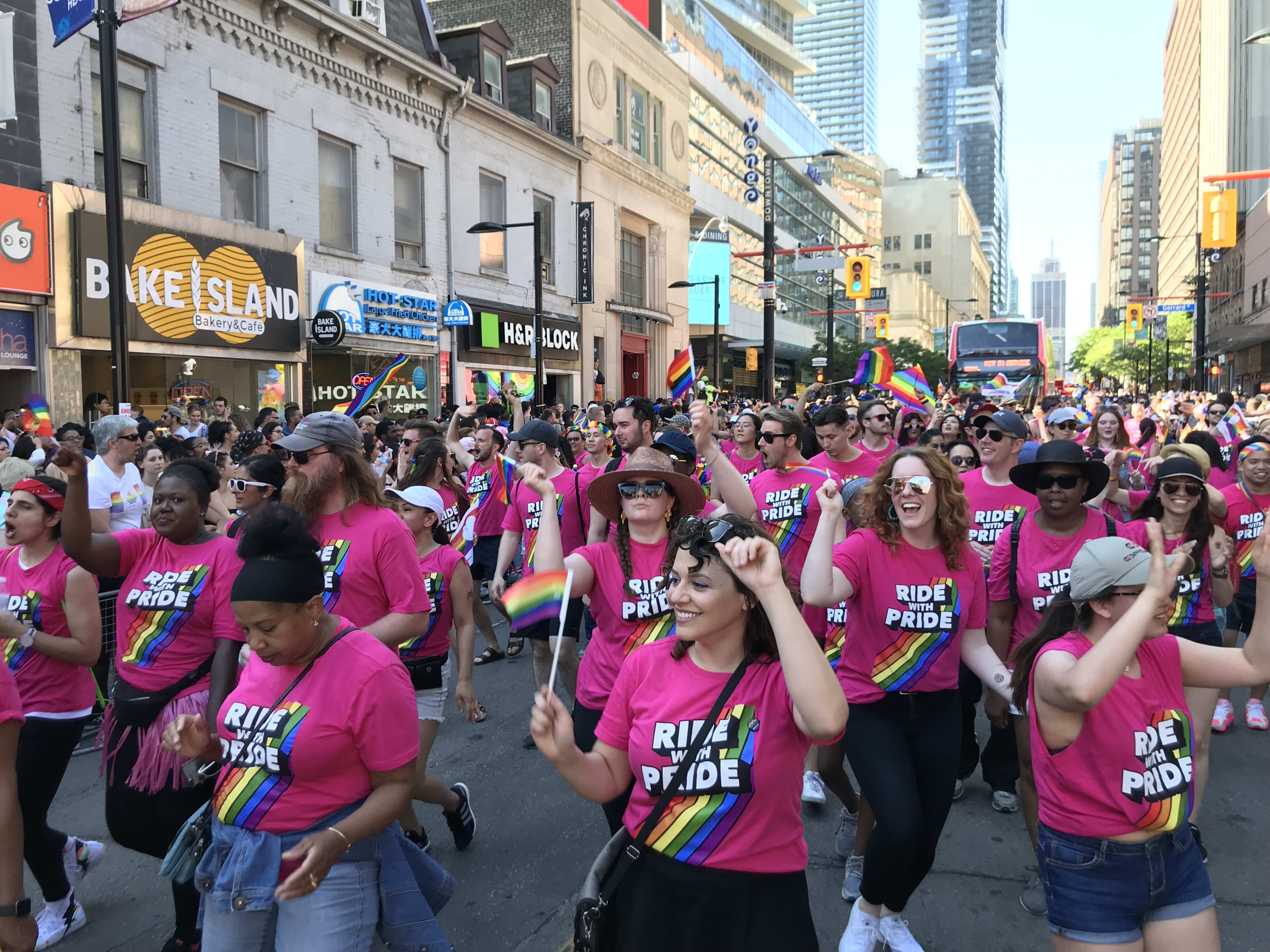 A group of people in a parade celebrating Pride