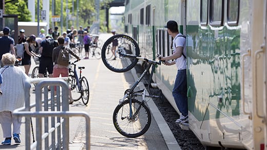 Man exiting a GO train with a bike
