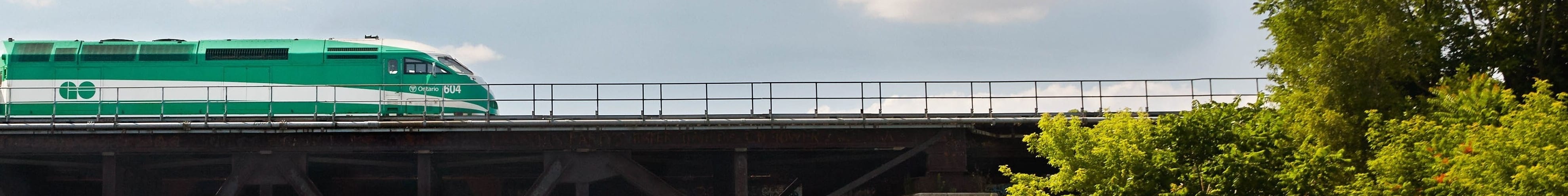 kayaker approaching GO Train bridge
