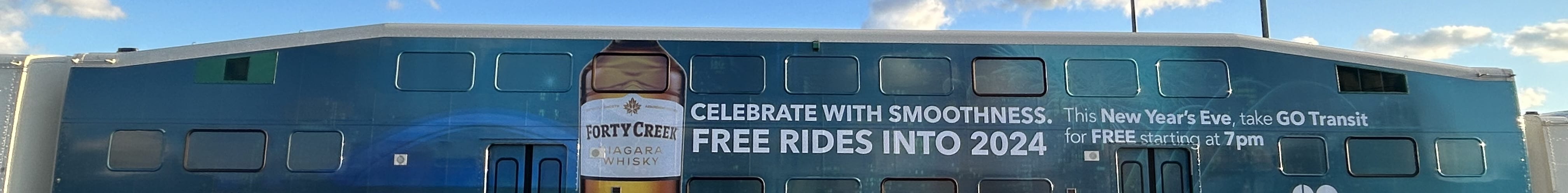Train wrap promoting free GO rides for NYE courtesy of Forty Creek Whisky.