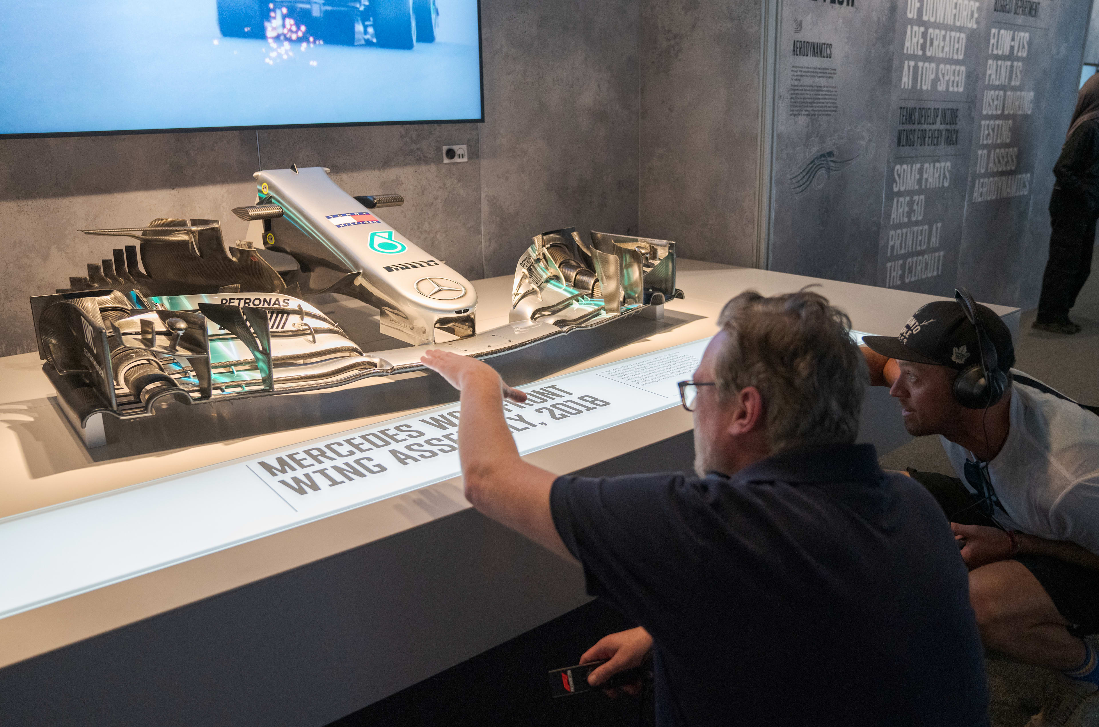 Two people looking at an F1 display