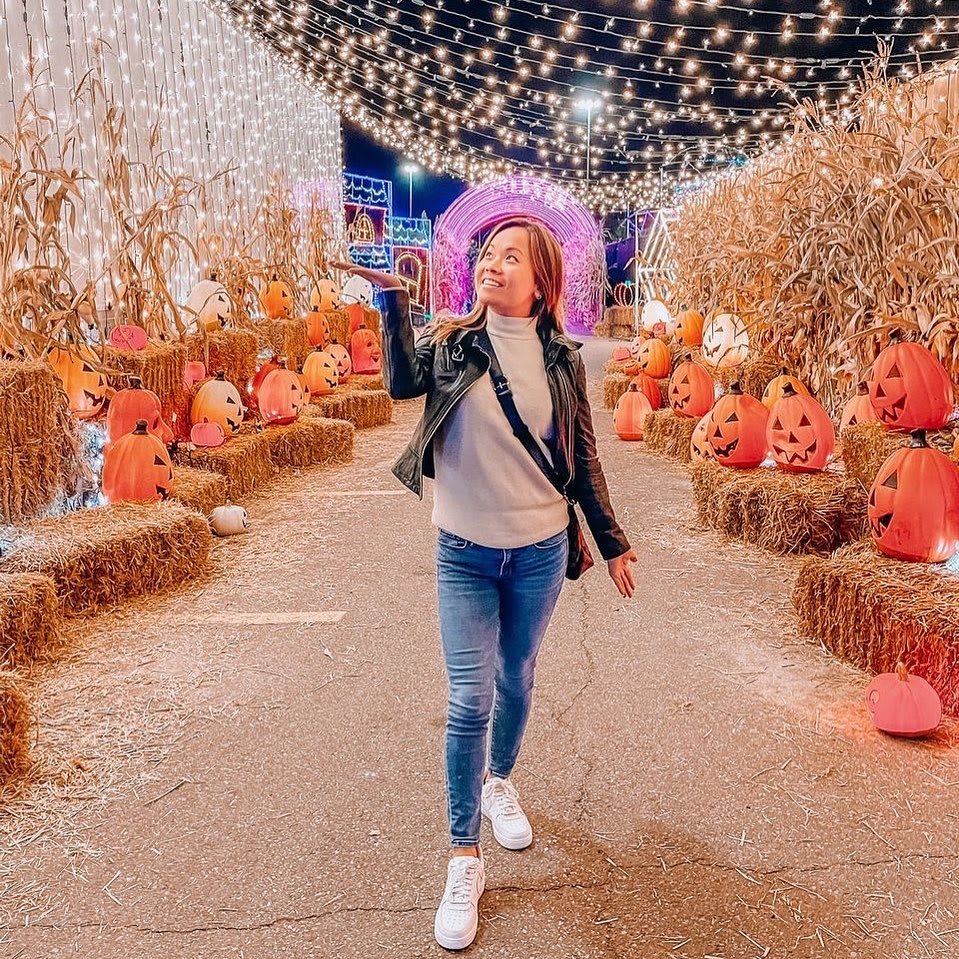 A woman walking through Halloween Nights of Lights