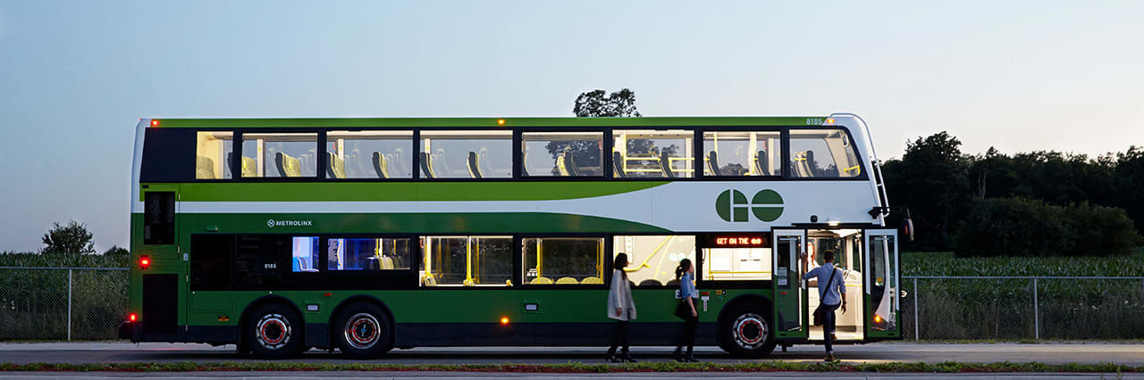 A bus picks up passengers.