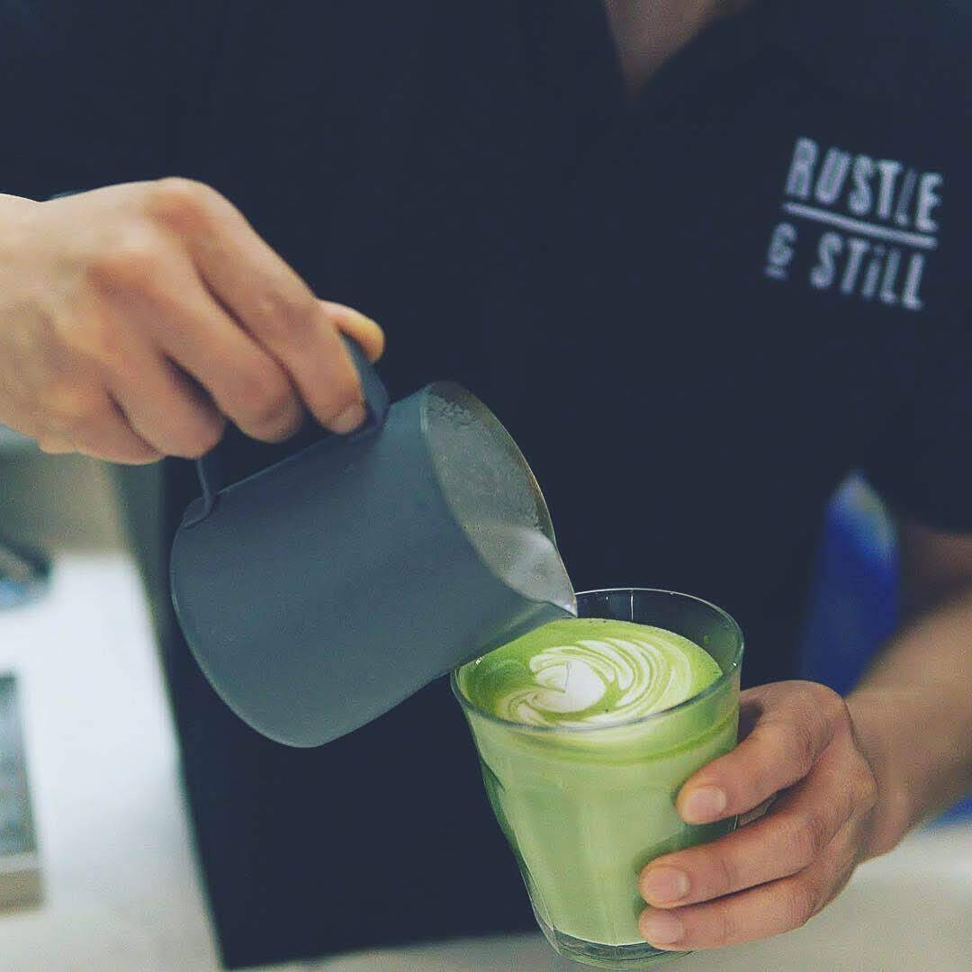 Employee making matcha latte art