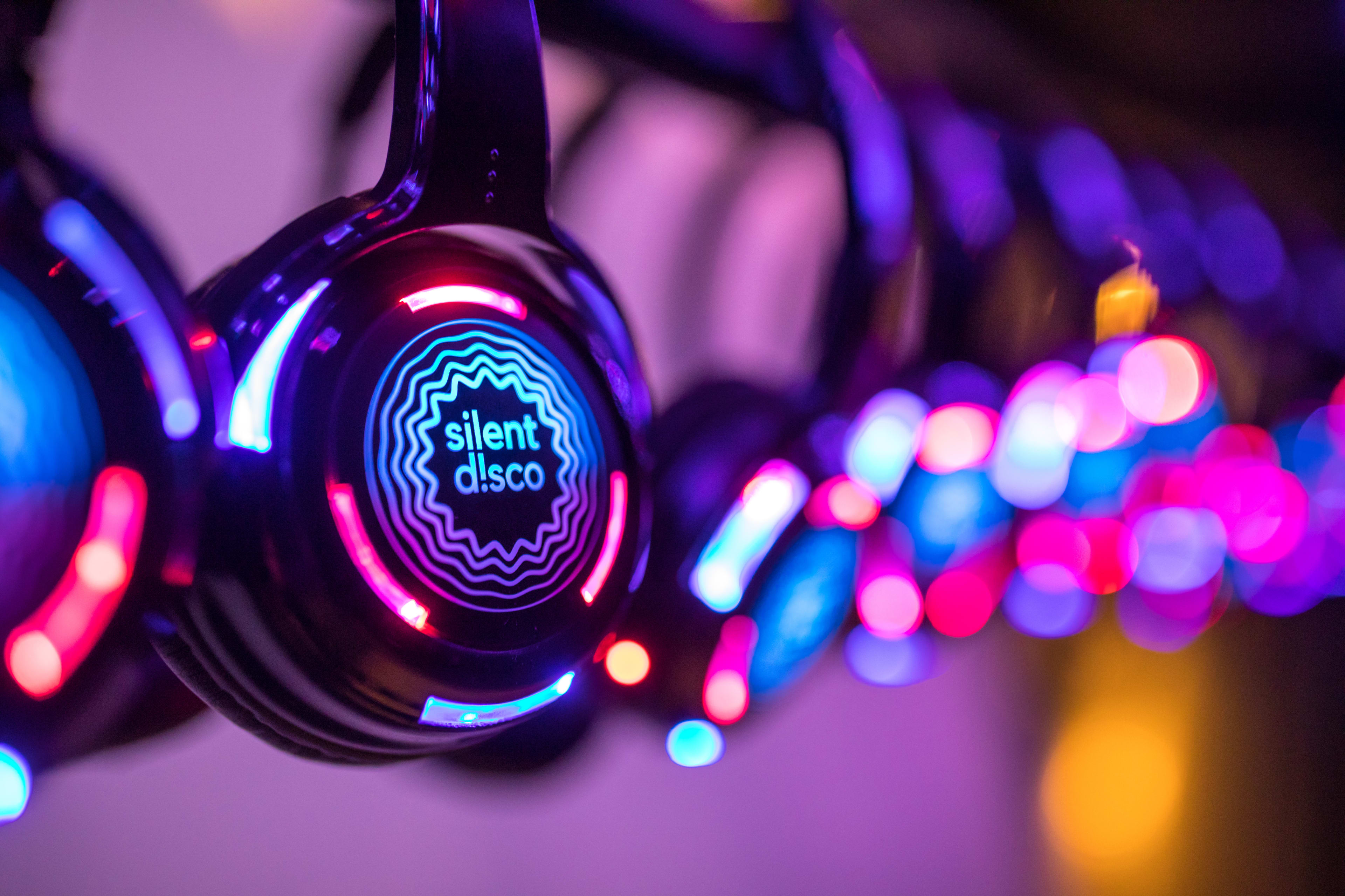 Row of glow-up over-the-head headphones for silent disco