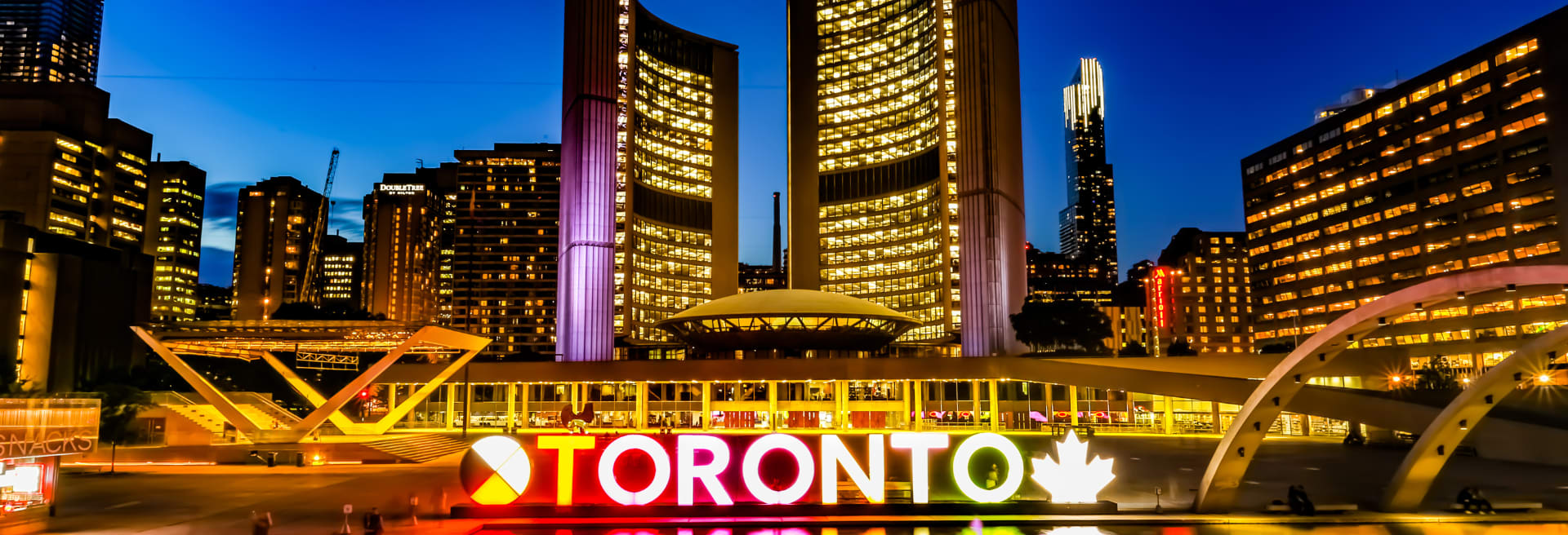 Toronto City Hall at night with sign lit up